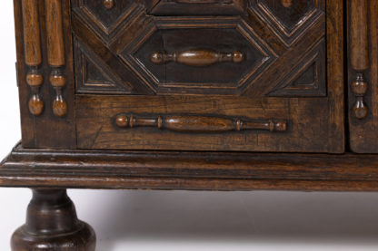 Late 17th/Early 18th Century Oak Cupboard Adorned With Decorative Geometric Mouldings And Split Spindle Appliqués.