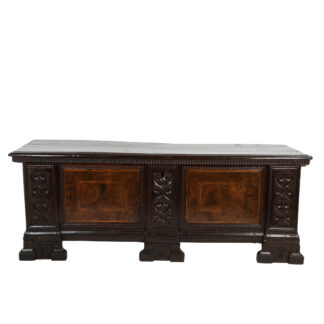 Italian 18th century walnut and oak cassone with burl walnut panels flanked by carved reliefs that extend to the front of the feet, hinged plank top with dental molding apron; Italian circa 1770.
