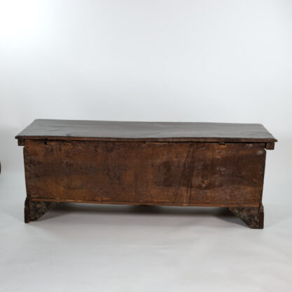 Italian 18th century walnut and oak cassone with burl walnut panels flanked by carved reliefs that extend to the front of the feet, hinged plank top with dental molding apron; Italian circa 1770.