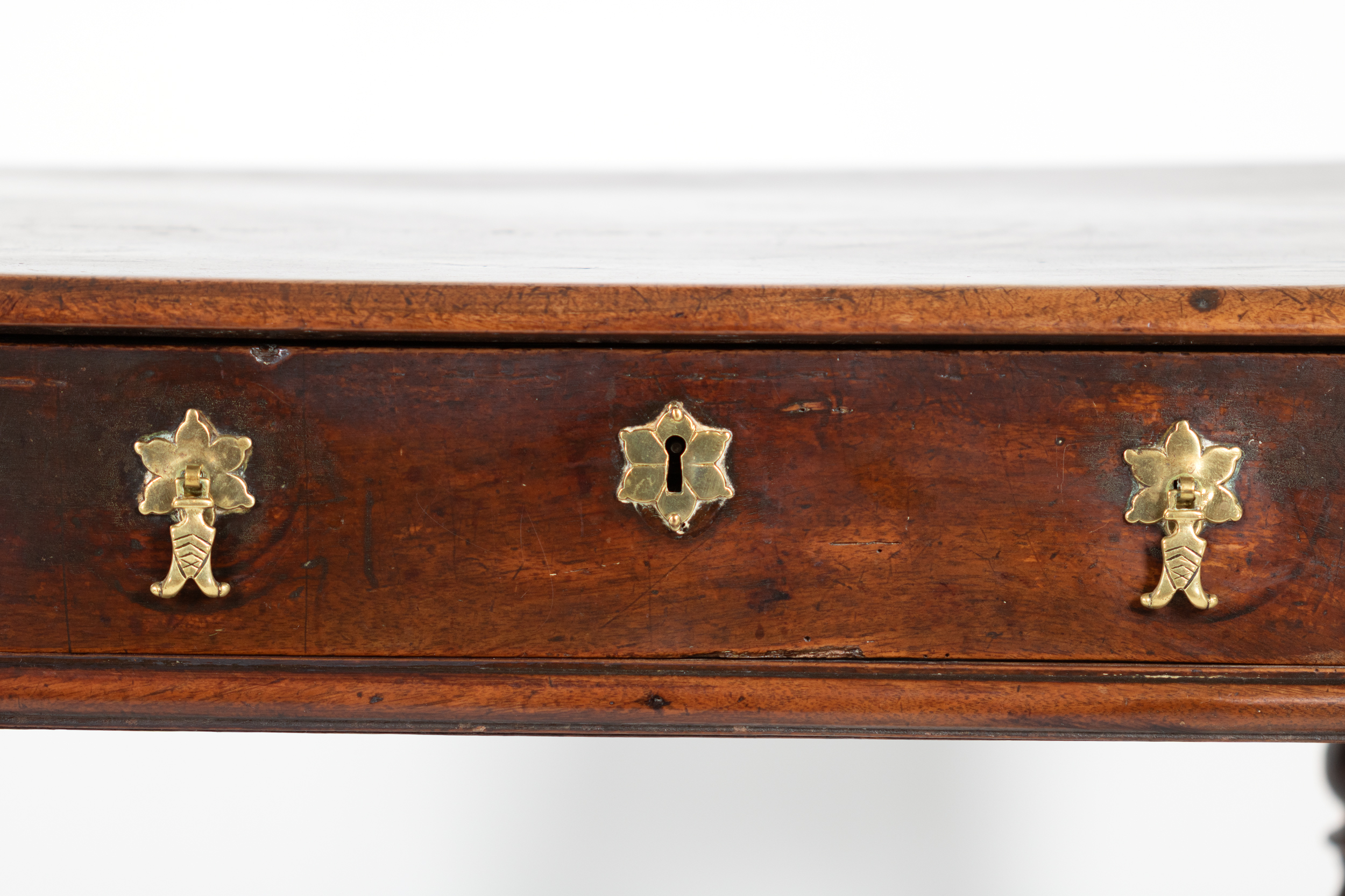 Close-up of brass drawer pulls and escutcheon on oak side table