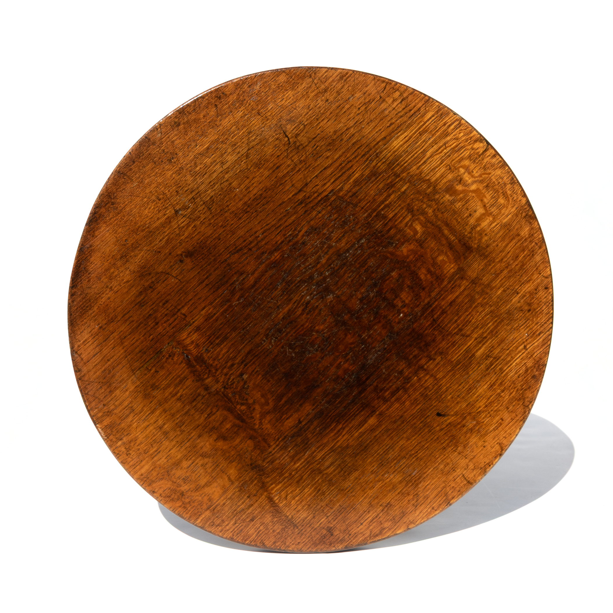 Circular oak tabletop with grain and wear, English cocktail table