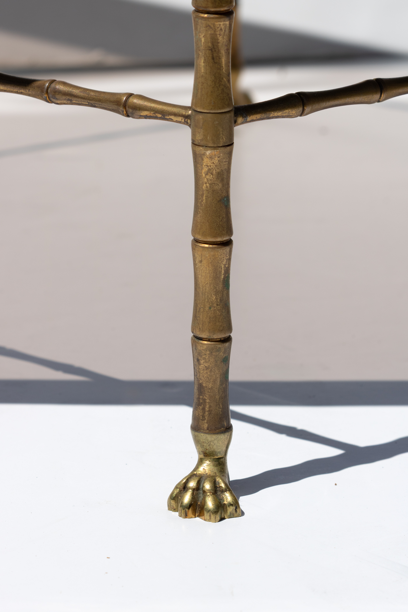 Detail of brass paw foot and bamboo leg Maison Baguès table
