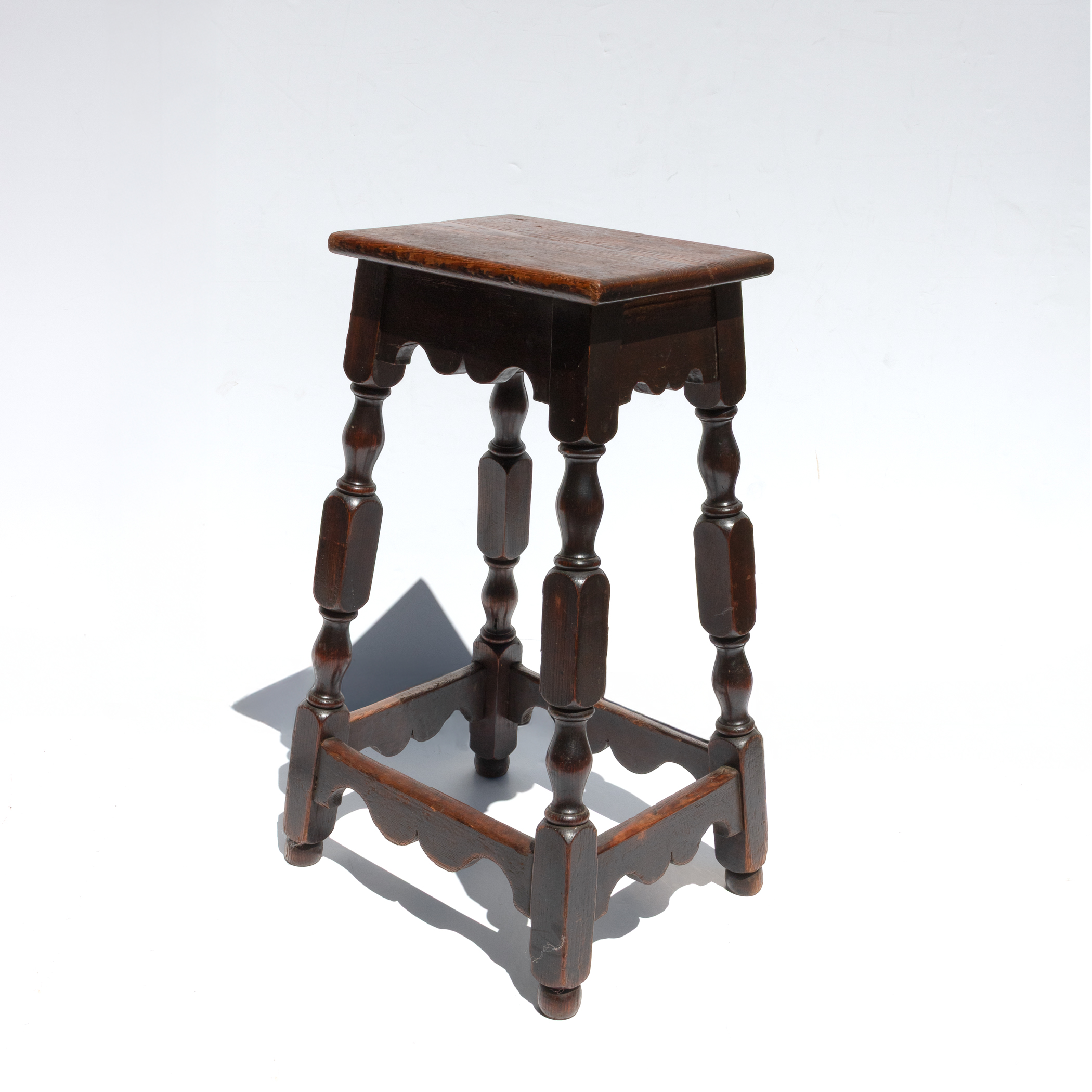 Very tall English joint stool, circa 1870, photographed with background
