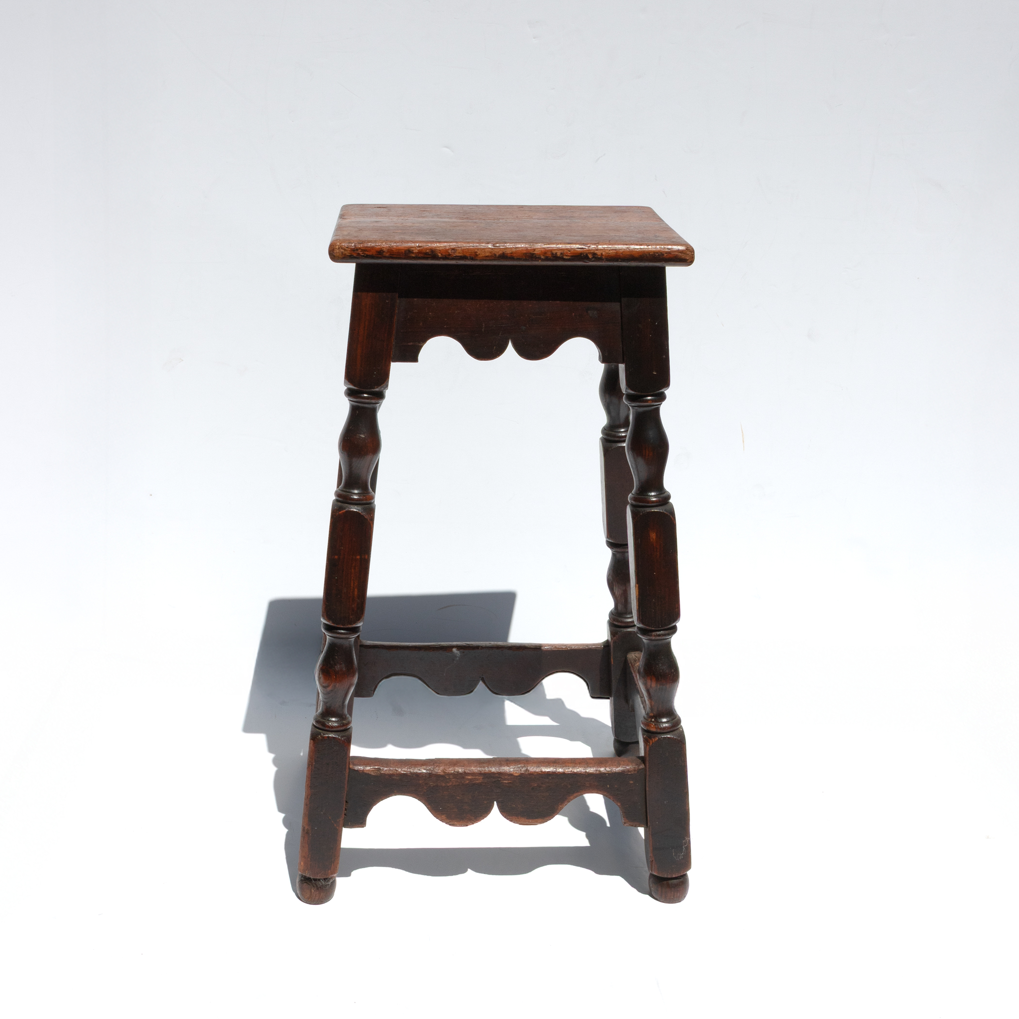 Front view of very tall English joint stool, circa 1870