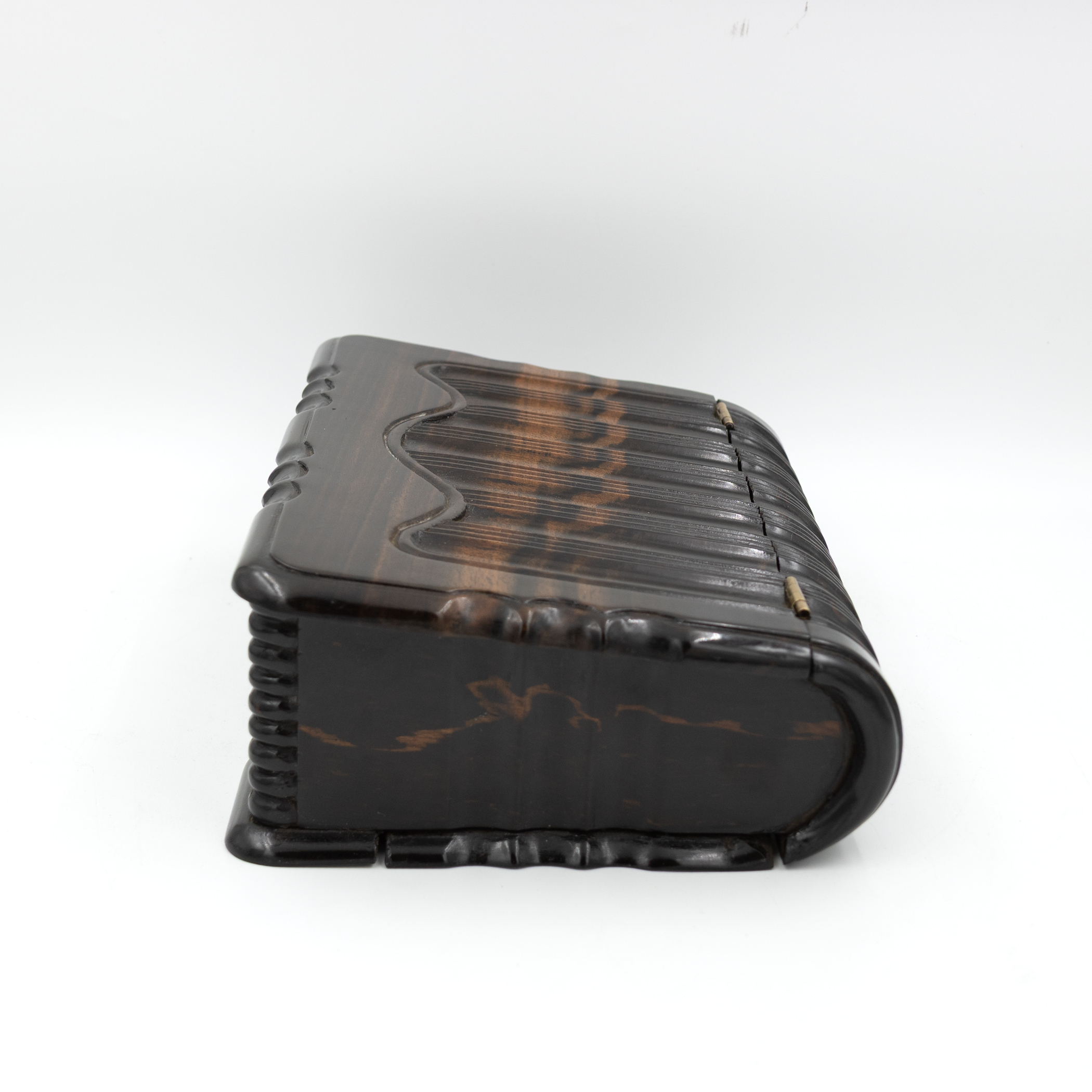 Profile view of antique wooden book box showing concave page simulation