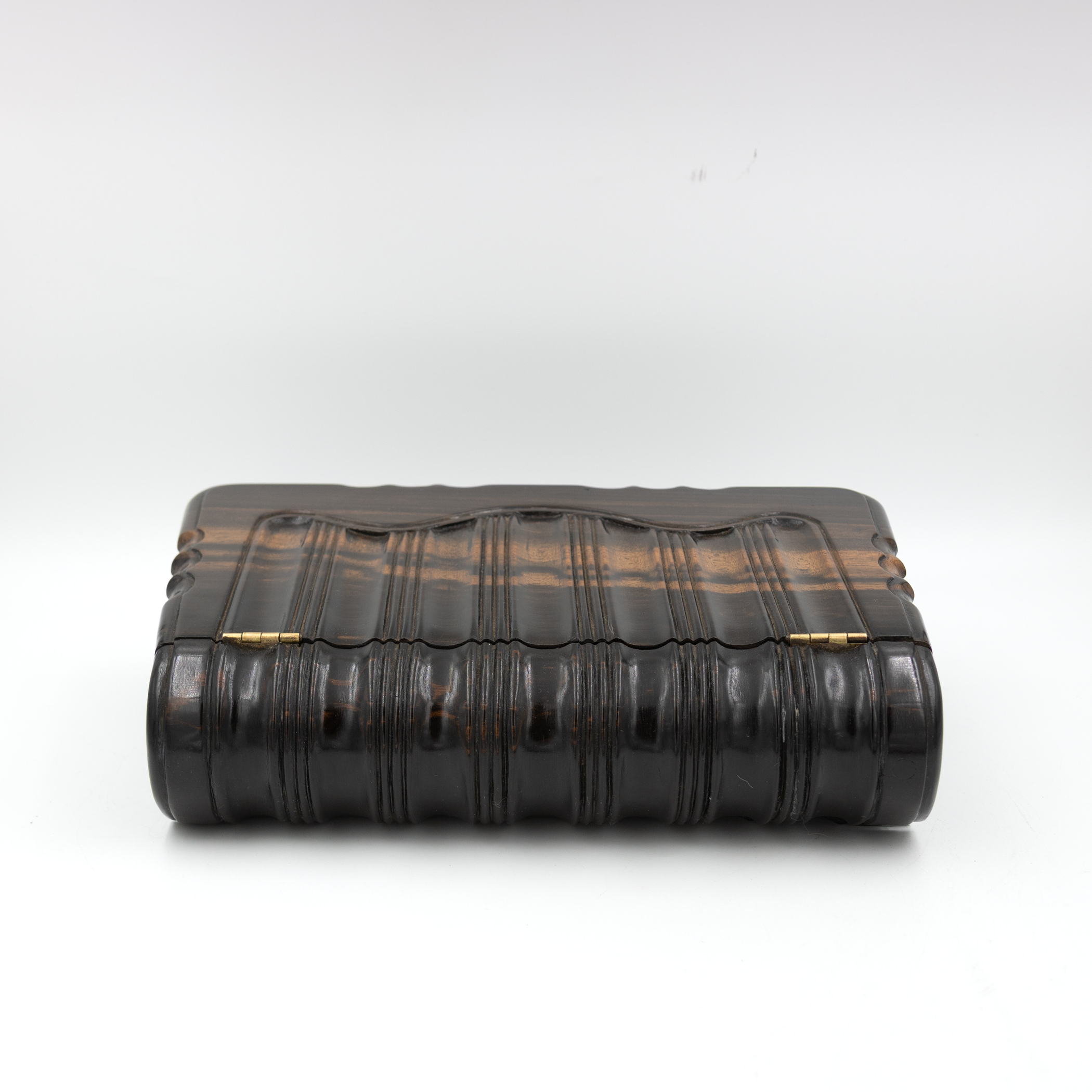 Detailed view of the spine of a wooden book box with raised bands