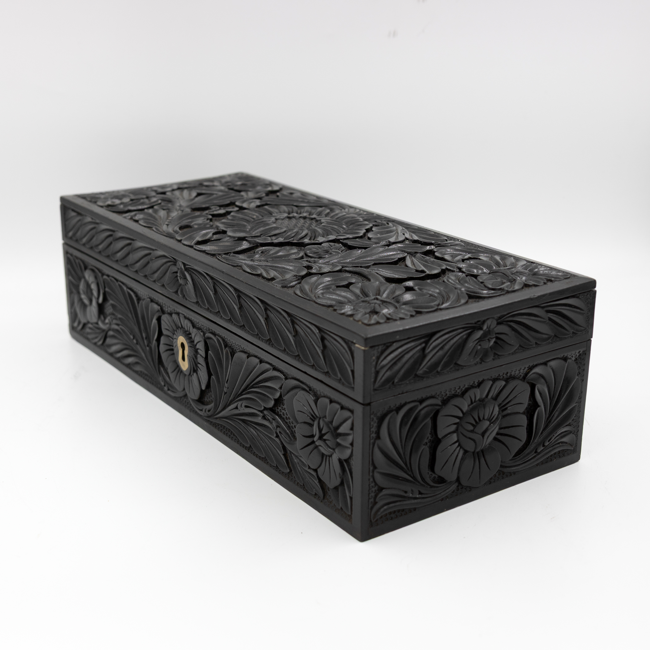Anglo-Indian ebony glove box three-quarter view showing carved sides