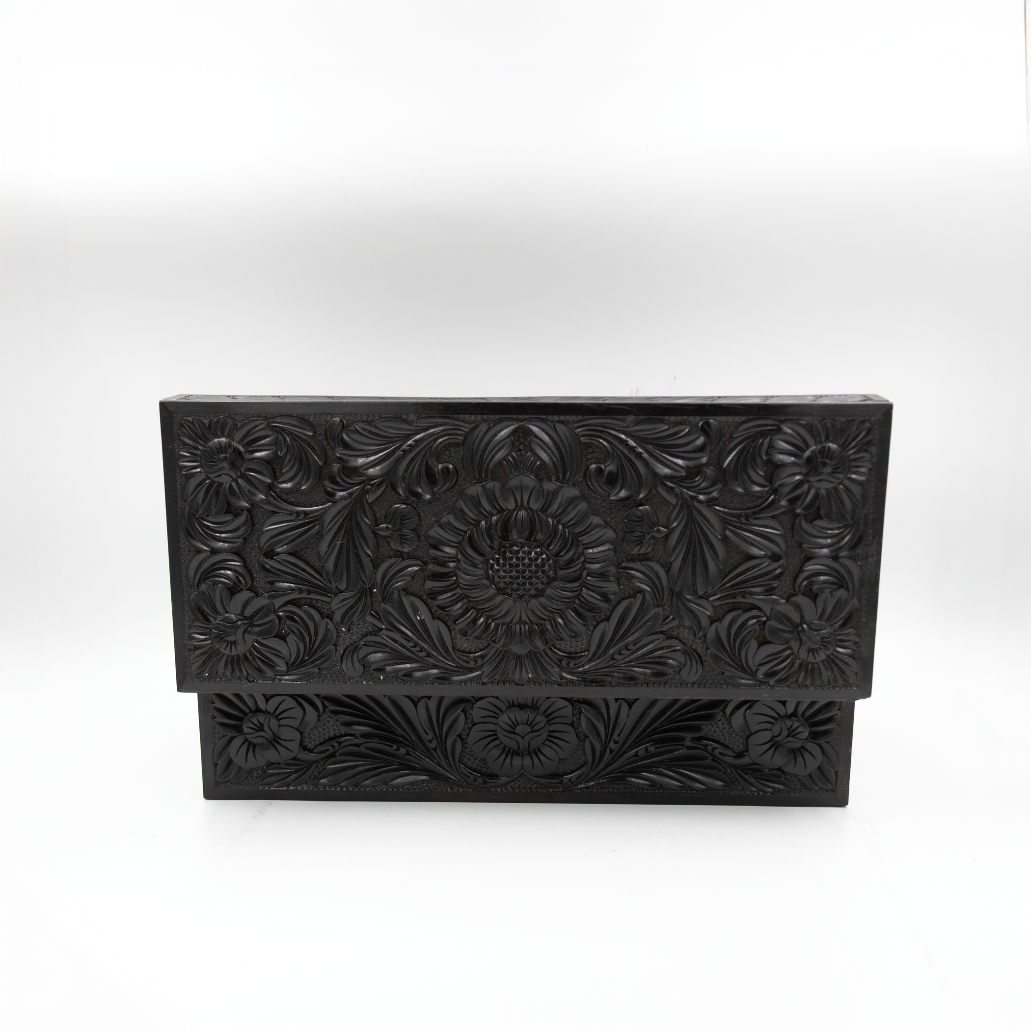 Carved lid of ebony box upright.