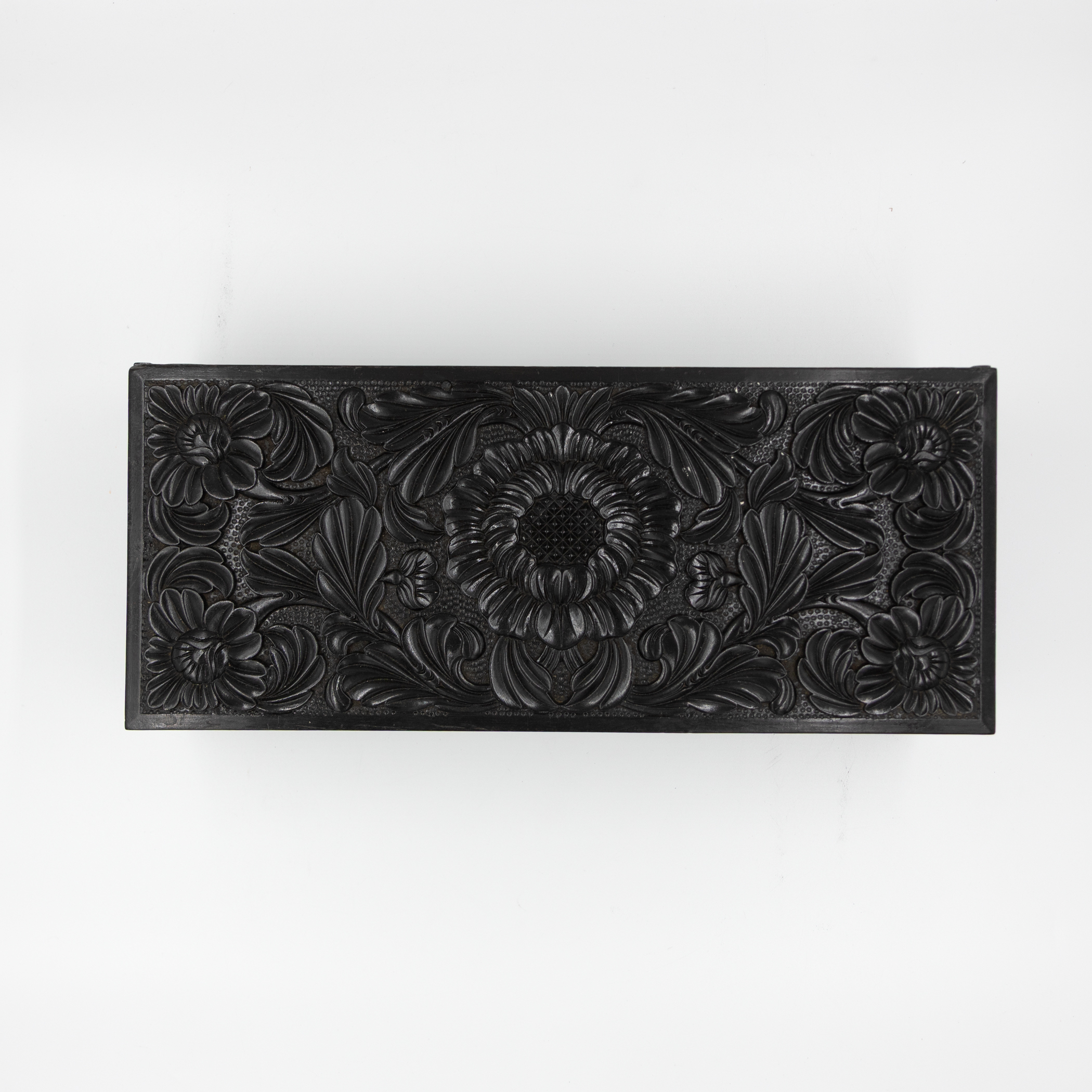 Top view of carved ebony box lid.
