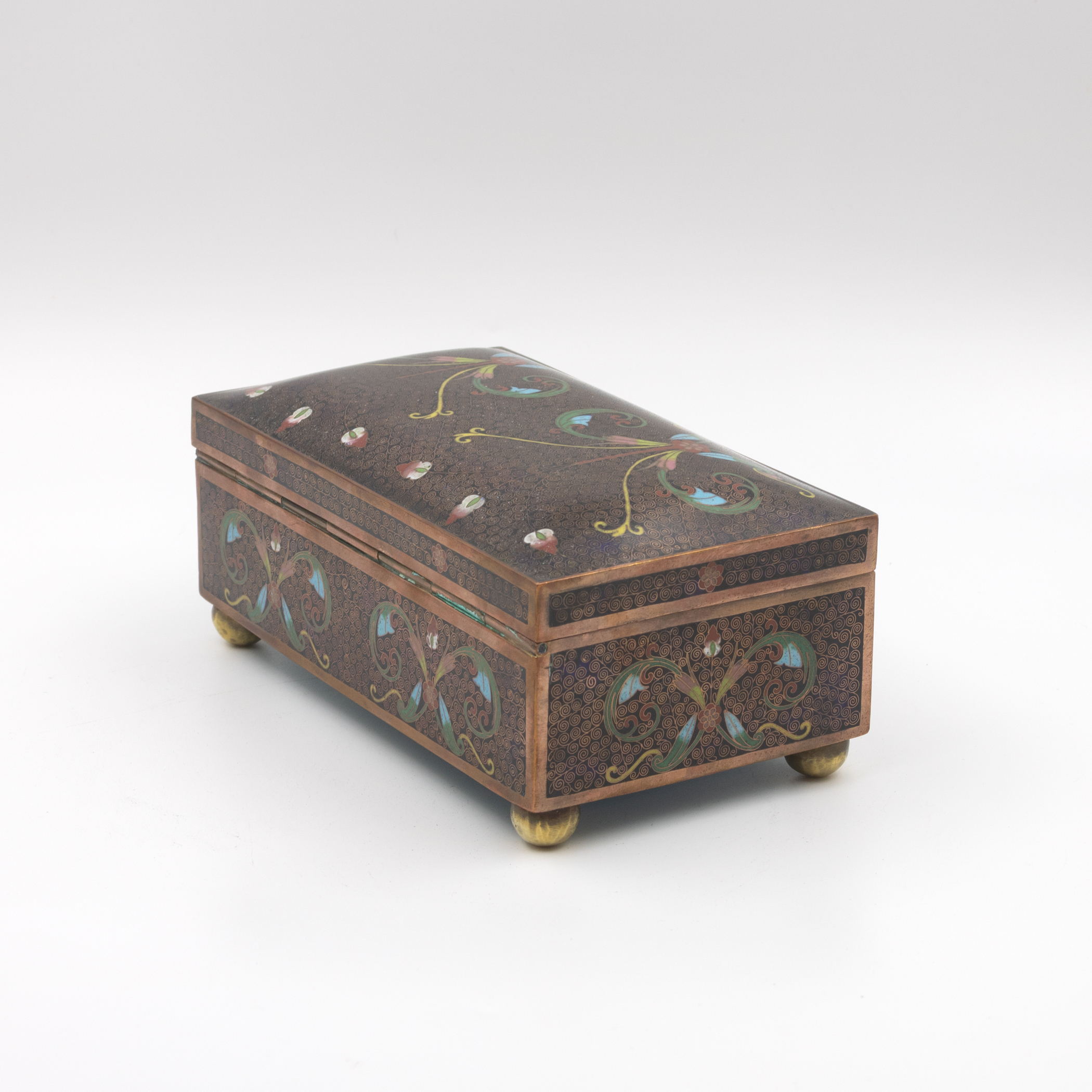 Cloisonné enamel box, rear three-quarter view from opposite angle, long back face and end panel, hinge detail, copper banding, ball feet