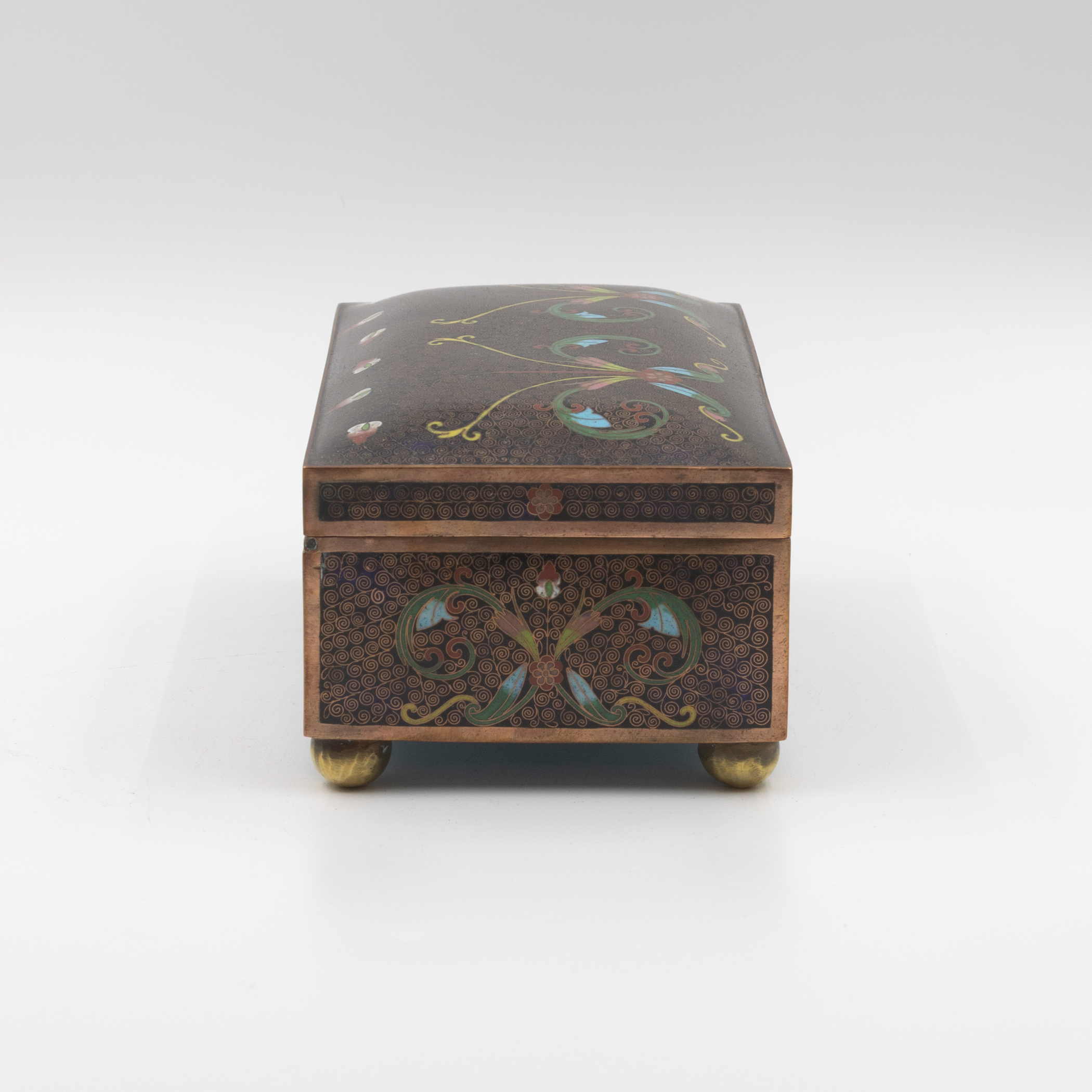Cloisonné enamel box, opposite end panel with centered foliate motif, copper banding, ball feet