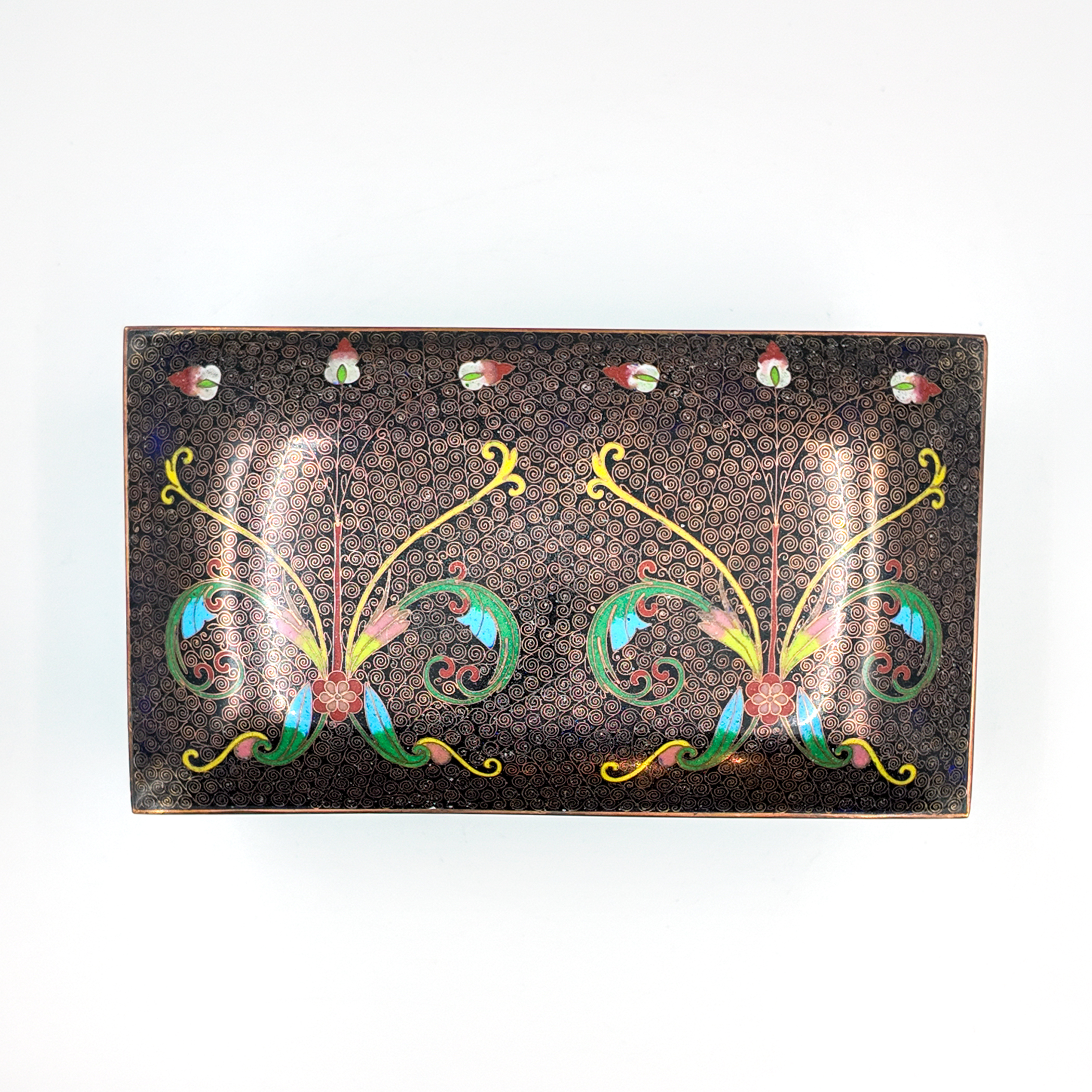 Cloisonné enamel box, overhead view of lid top with floral scrollwork decoration on dark spiral ground