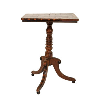 Rectangular Regency games table with chessboard top, oyster veneer border, ring-turned pedestal and three downswept legs with bun feet.
