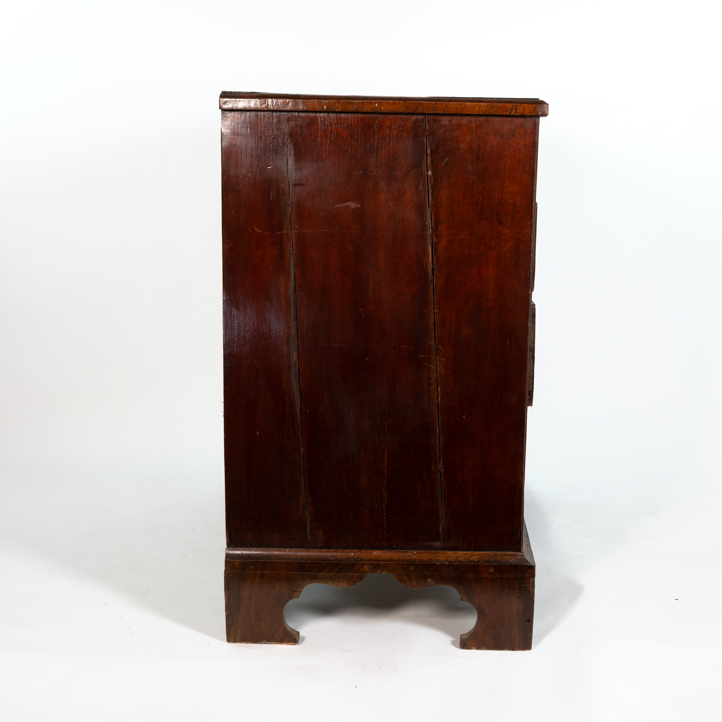 Side view of George II walnut chest of drawers, English circa 1720, showing oak sides and bracket foot base, Garden Court Antiques San Francisco