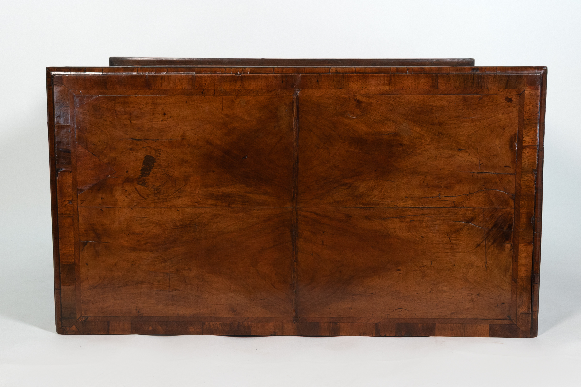 Surface detail of George II walnut chest of drawers, English circa 1720, bookmatched walnut top with patina and wear, Garden Court Antiques San Francisco