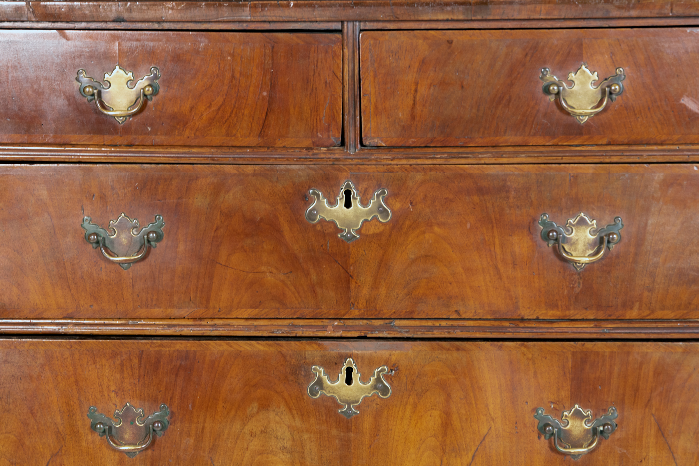 Drawer and brass bail handle detail on George II walnut chest of drawers, English circa 1720, figured walnut fronts, Garden Court Antiques San Francisco