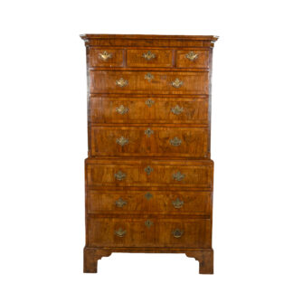 Georgian walnut chest on chest, English circa 1720, with fluted canted corners and moulded cornice