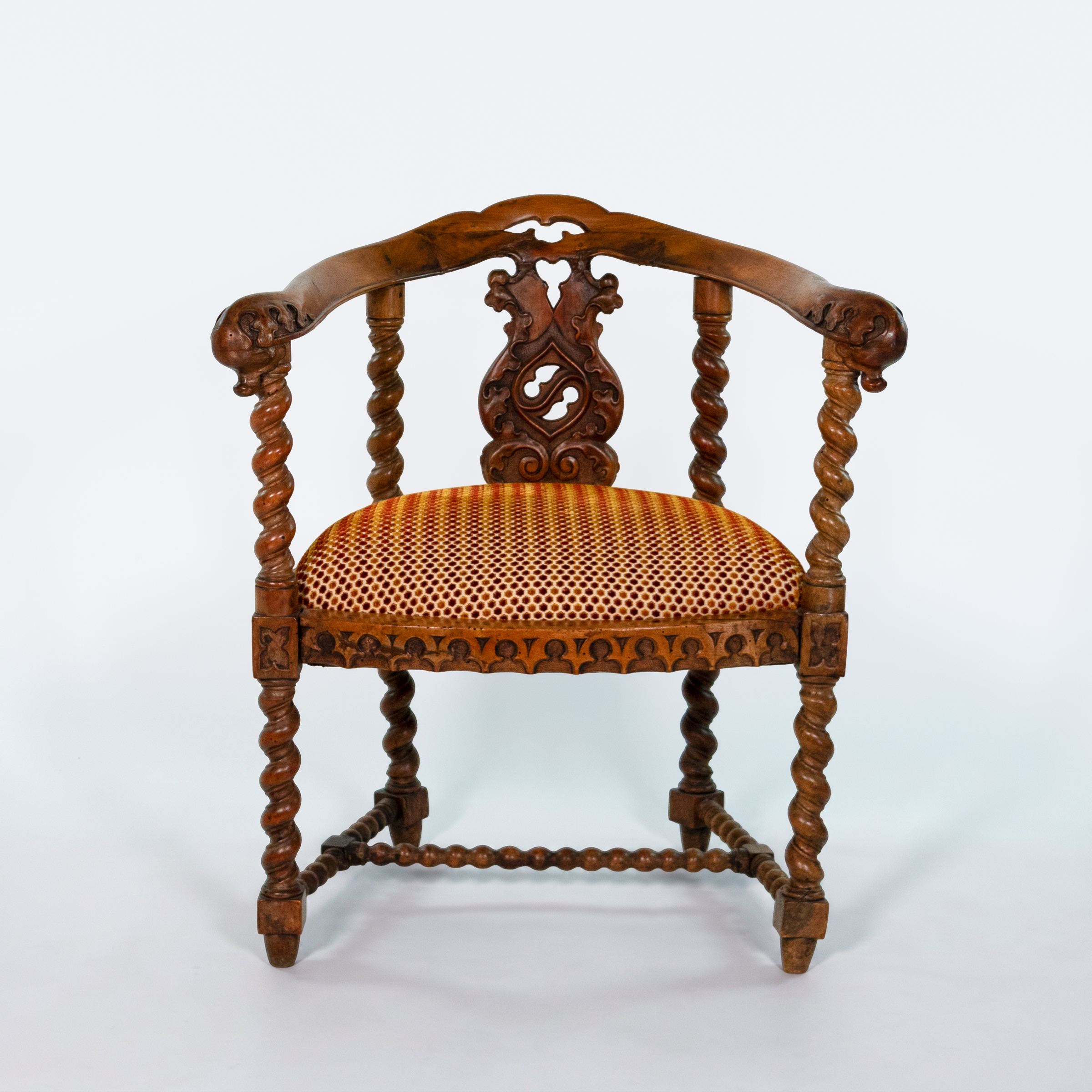 Front view of English Gothic Revival yew tub chair with barley-twist supports, circa 1880