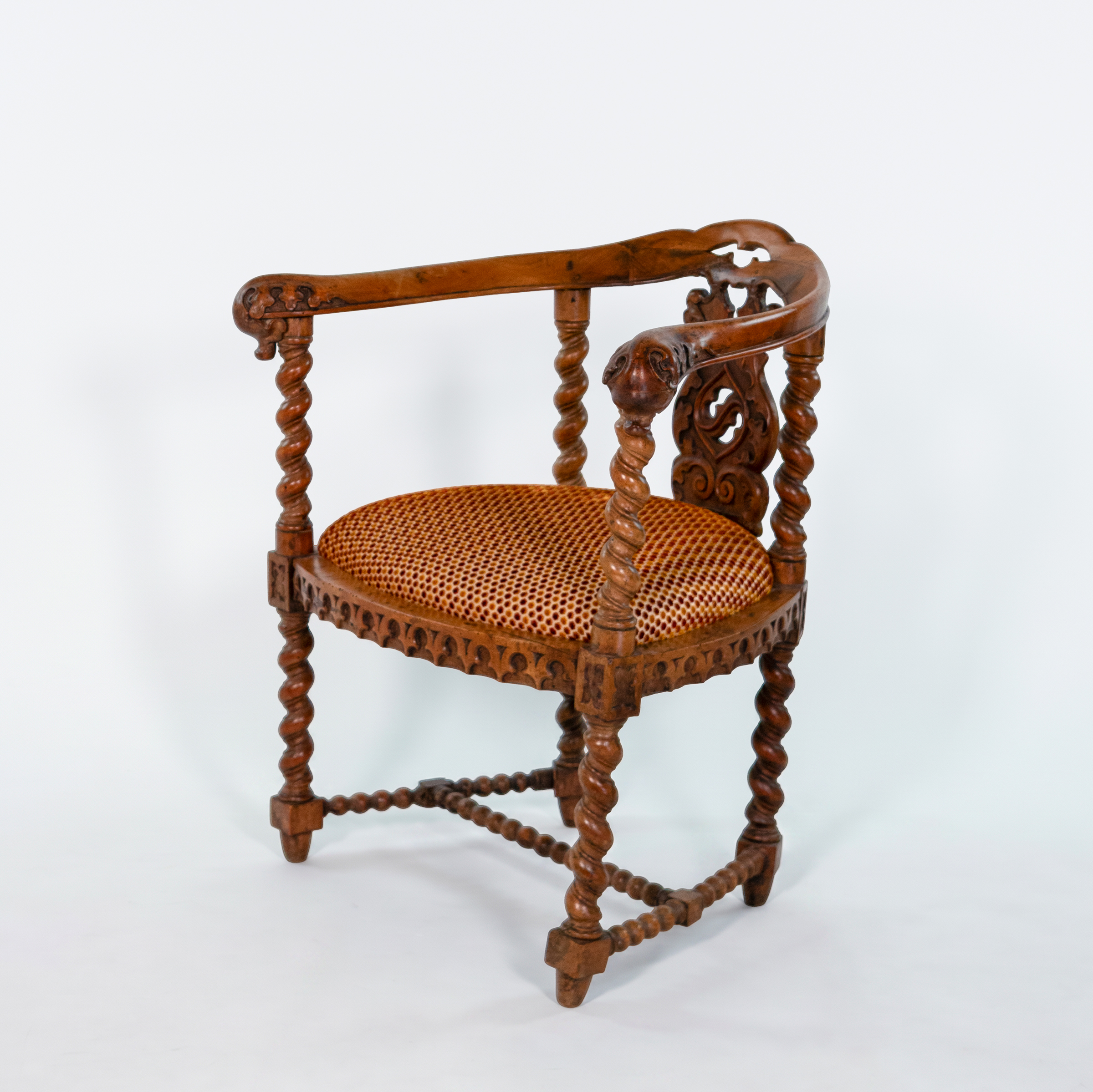 Three-quarter front view of English Gothic Revival yew tub chair with barley-twist supports