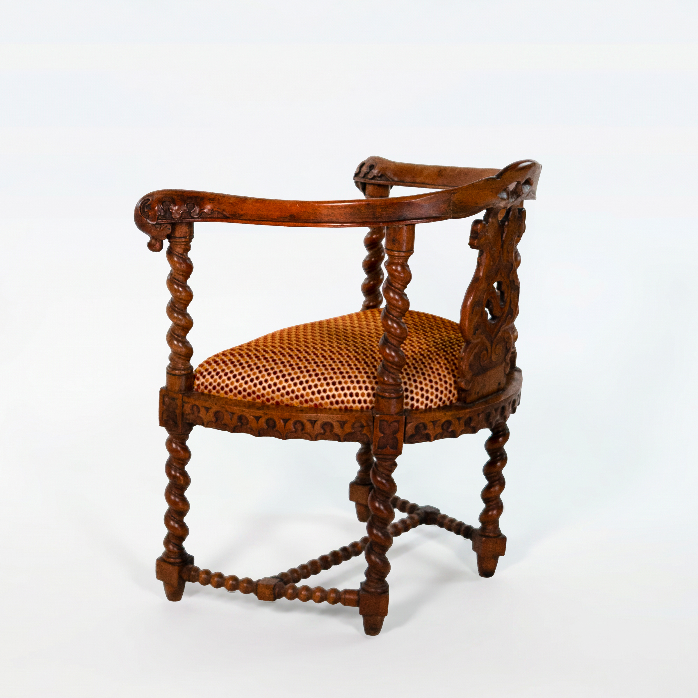 Rear three-quarter view of English Gothic Revival yew tub chair with pierced foliate splat