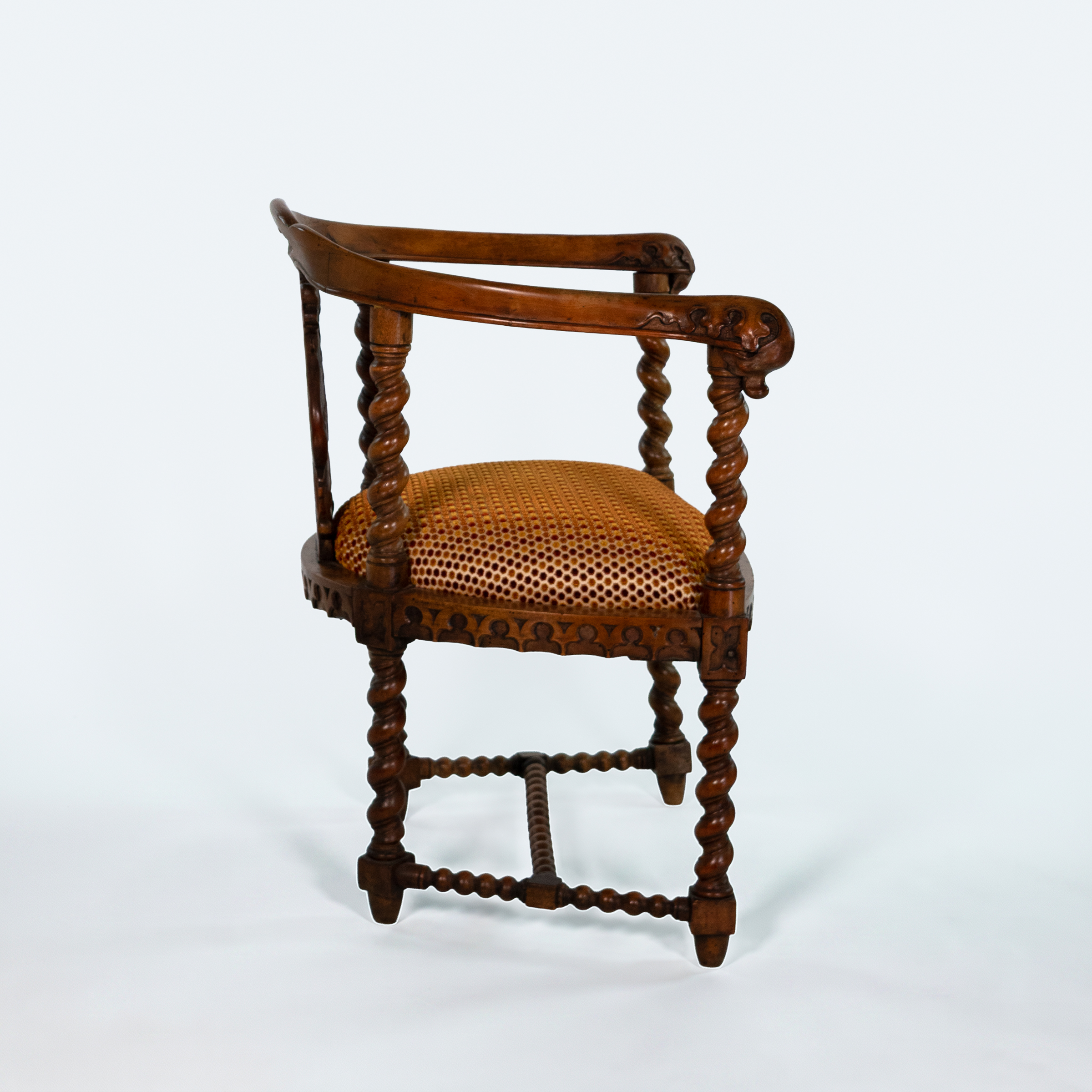Side view of English Gothic Revival yew tub chair with pierced foliate splat