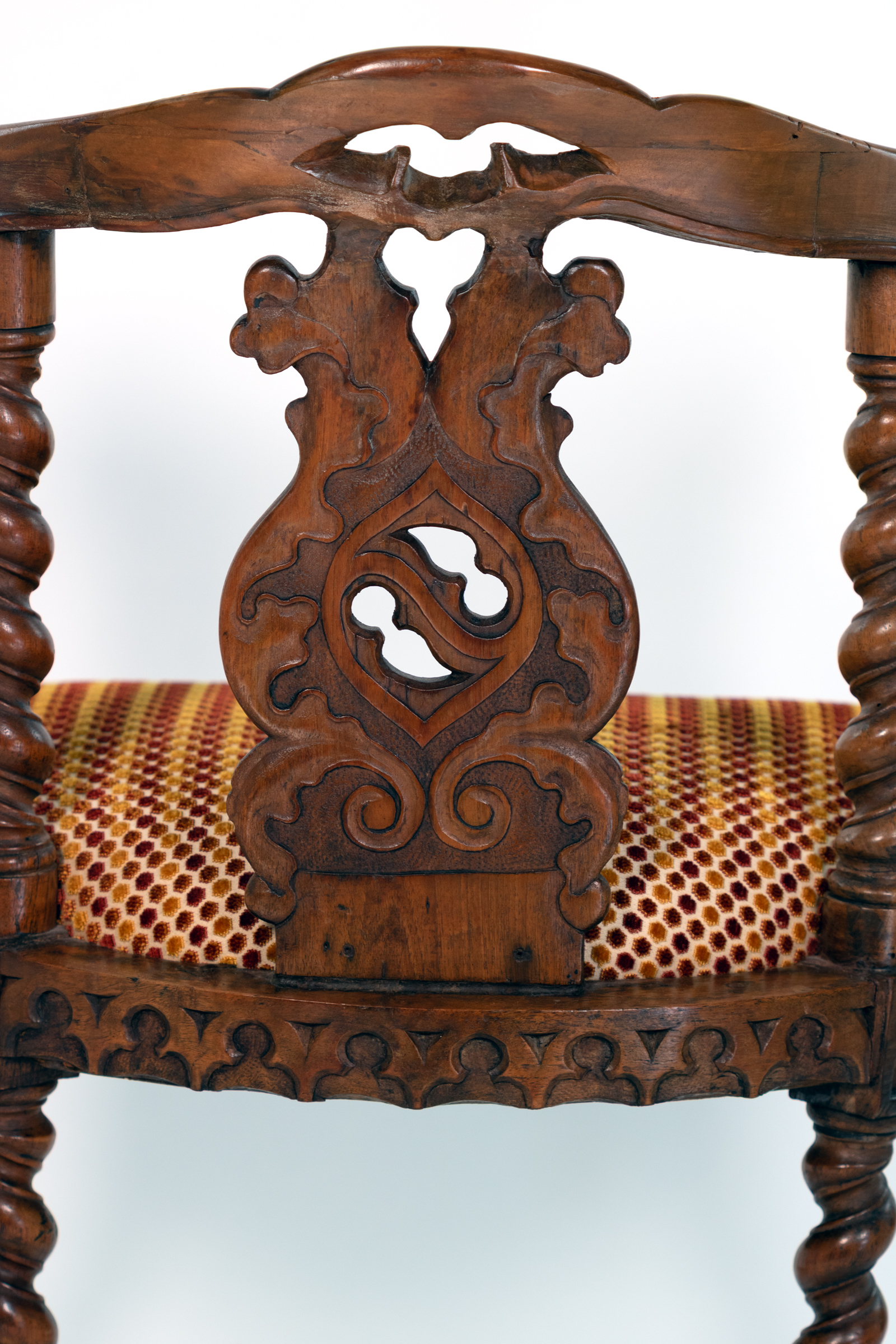 Detail of pierced foliate splat on English Gothic Revival yew tub chair circa 1880