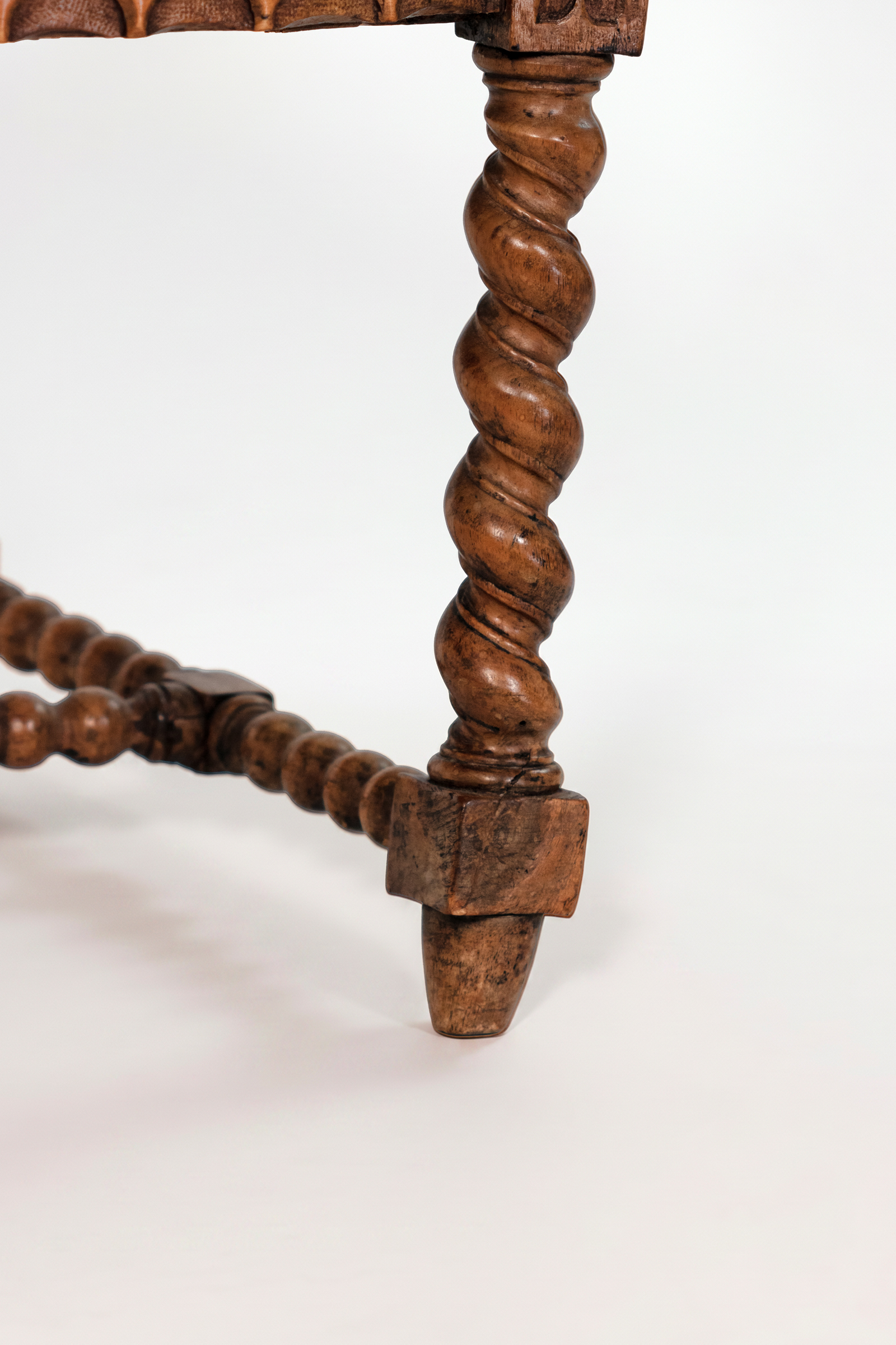 Detail of spool-turned stretcher and foot on English Gothic Revival yew tub chair