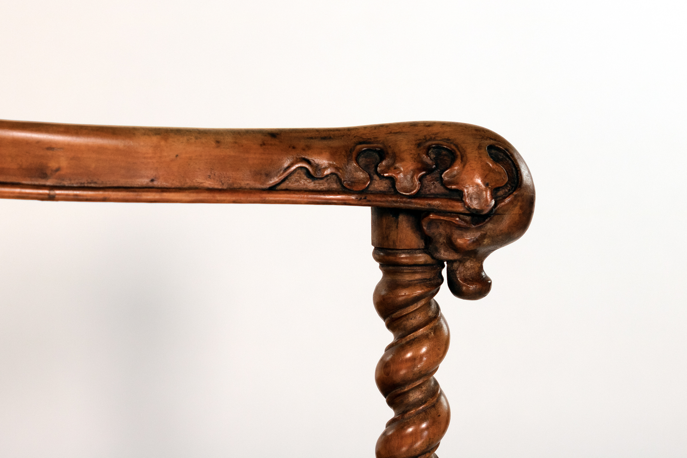 Detail of carved arm terminal and Gothic ornament on English Gothic Revival yew tub chair