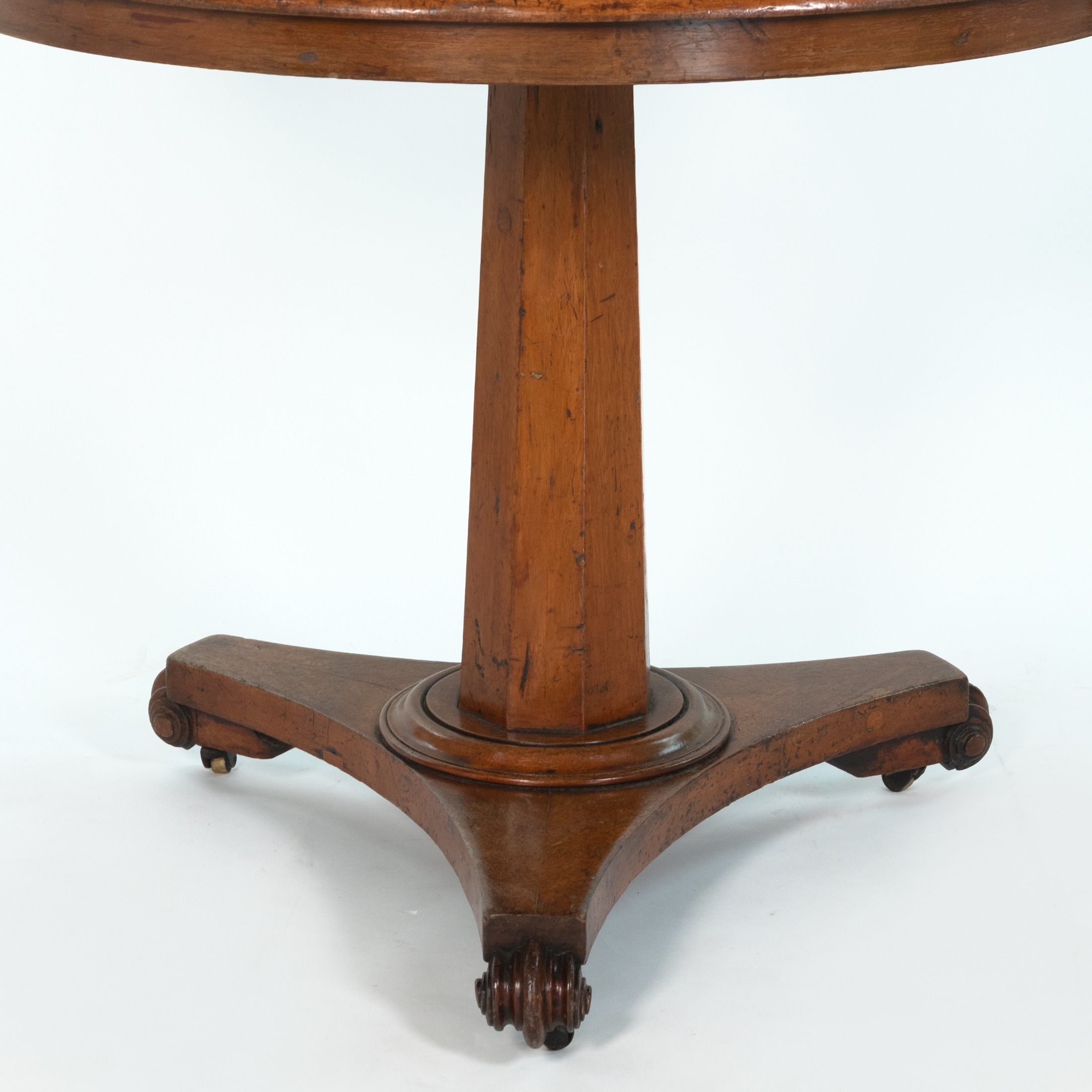 Detail of octagonal pedestal and tripod base of an English fruitwood center table, circa 1850