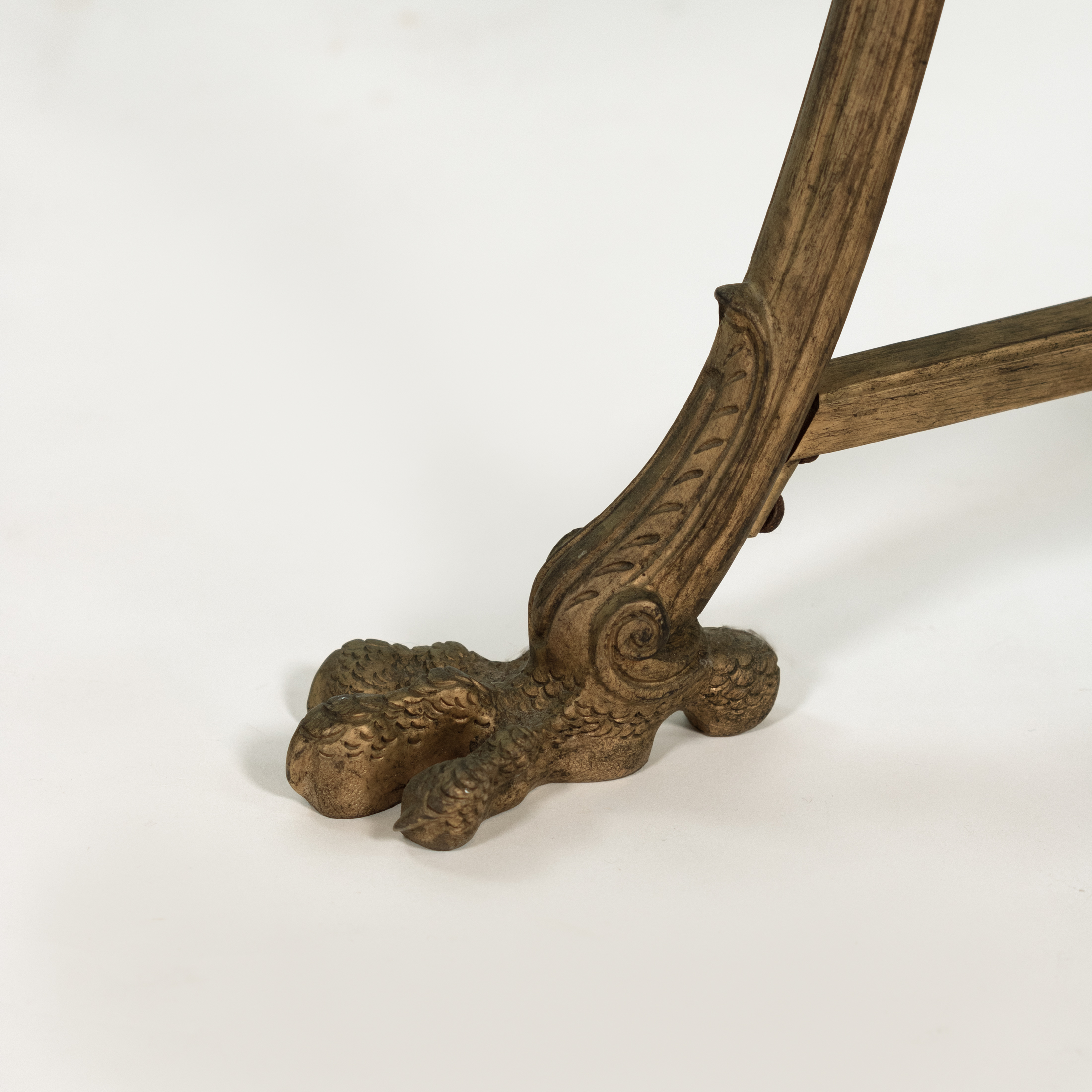 Close detail of a large bird-talon foot on a French gilt-bronze gueridon, circa 1880