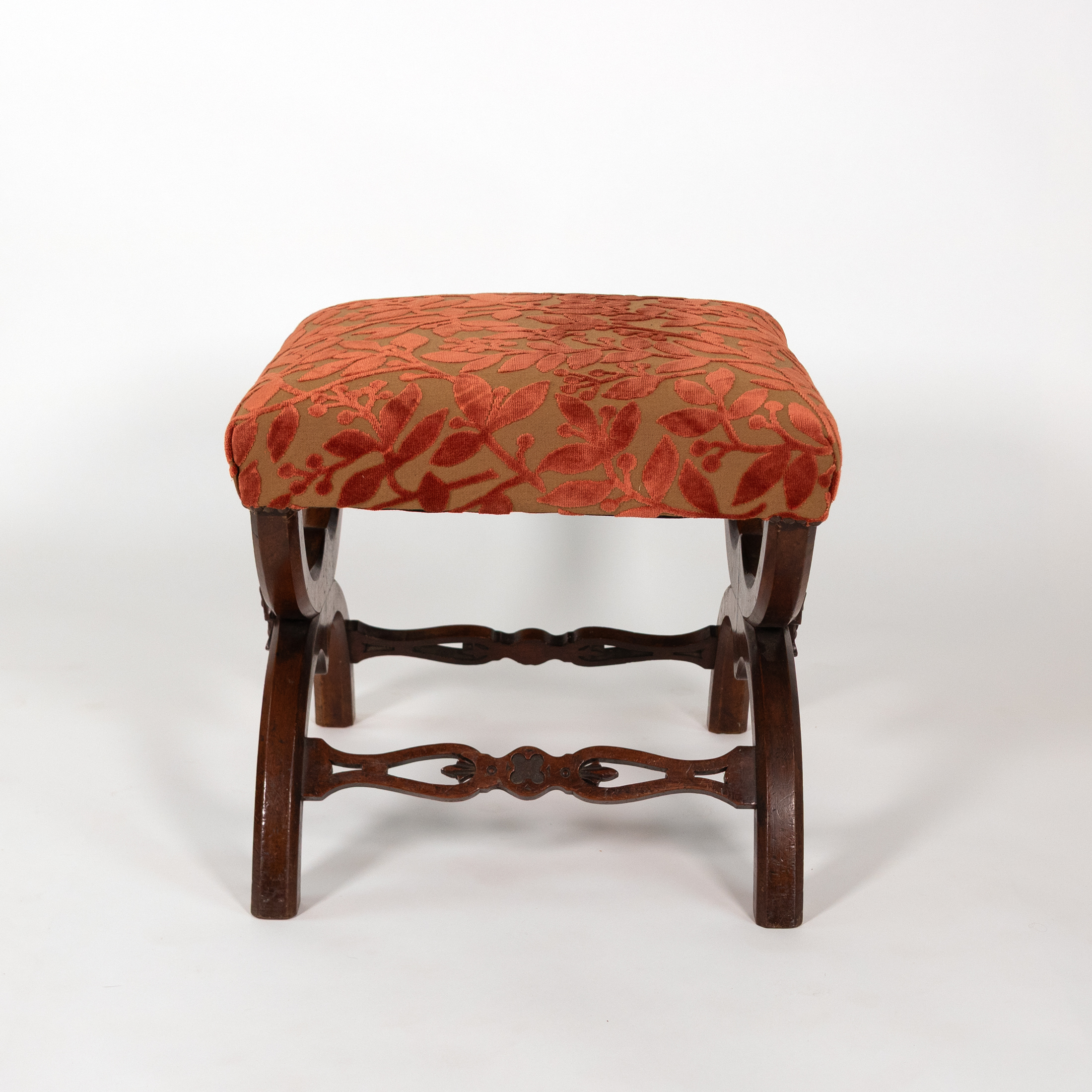 Walnut curule-form stool side view with pierced stretcher and flattened feet, French circa 1830