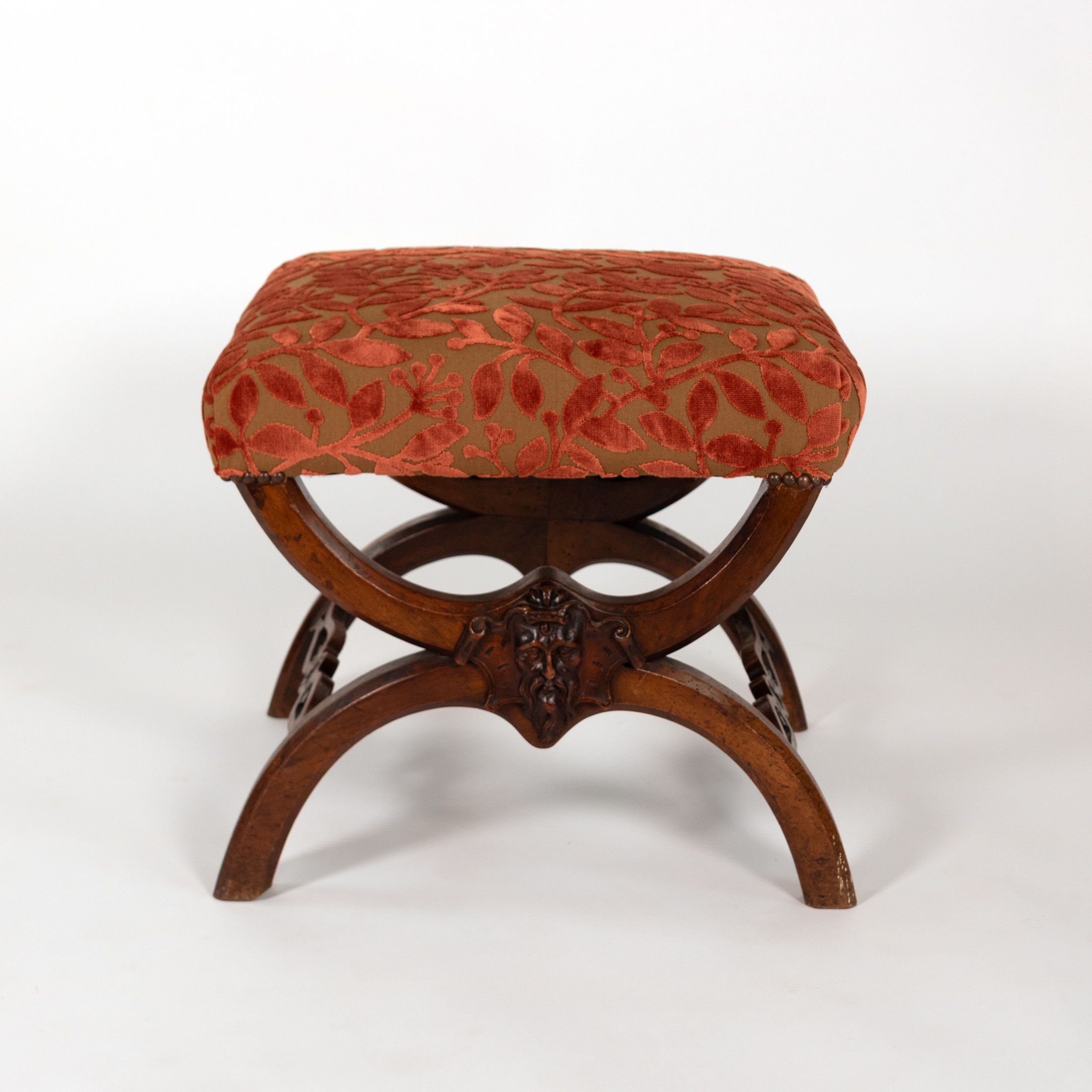 French walnut curule-form stool front view with carved bearded mask, circa 1830