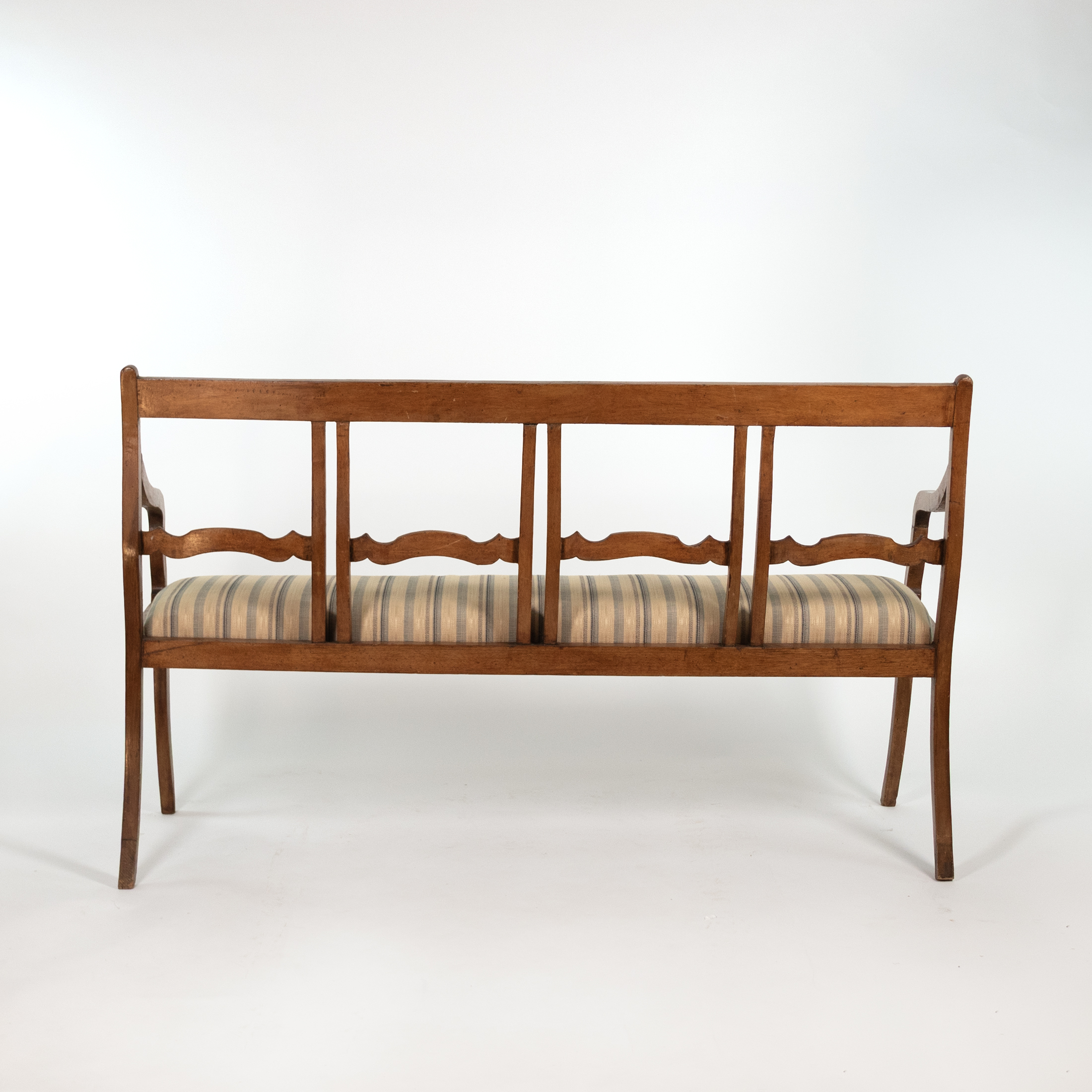 Rear view of Italian walnut bench circa 1880 with divided open back and scalloped horizontal rails