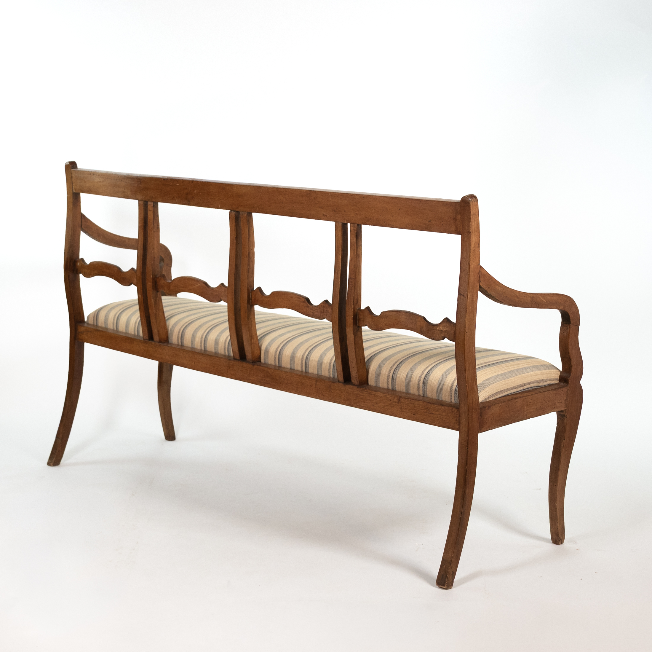 Opposite rear three-quarter view of Italian walnut bench circa 1880 with curved arm and sabre legs