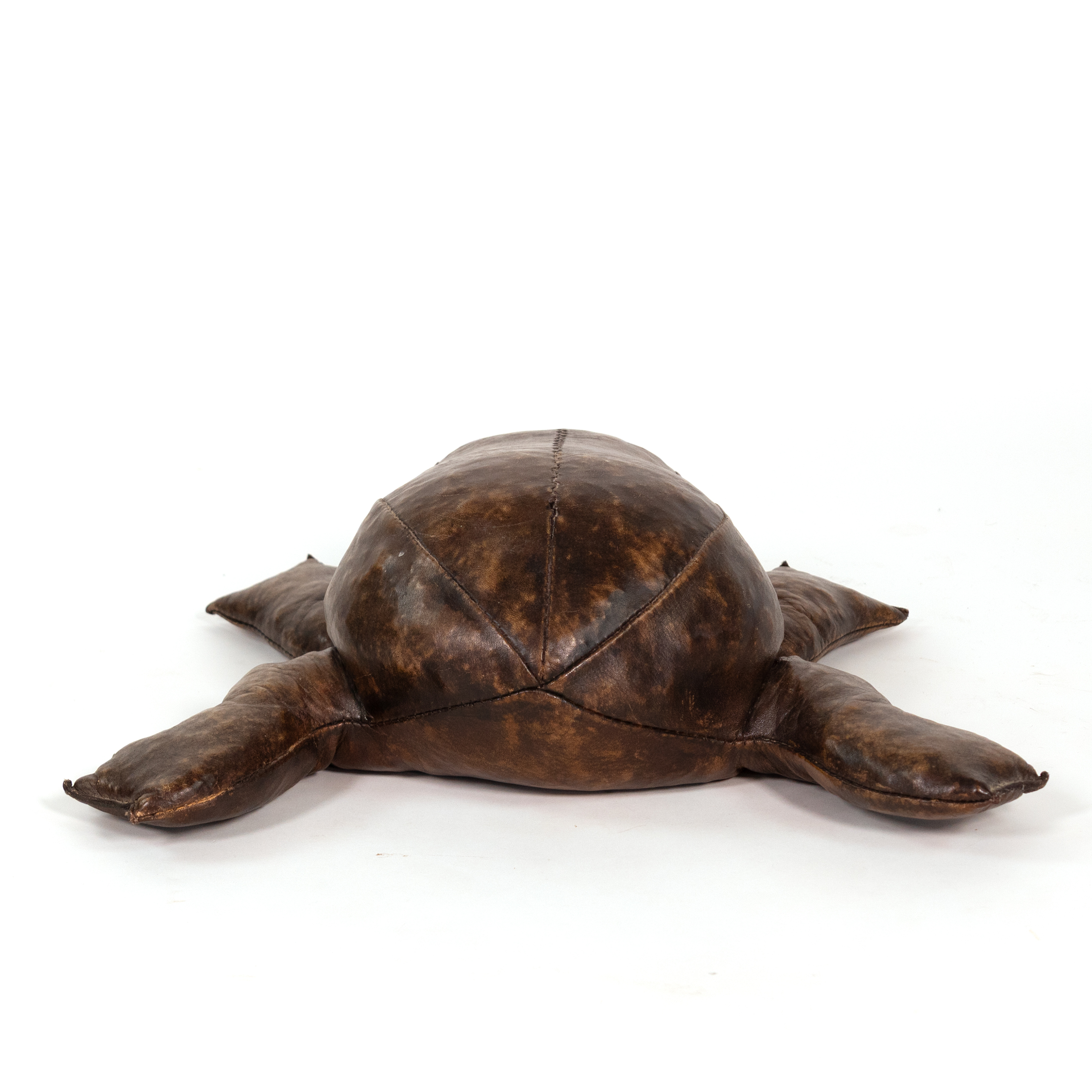 End view of leather frog footstool in the manner of Dimitri Omersa with central back seam and splayed feet