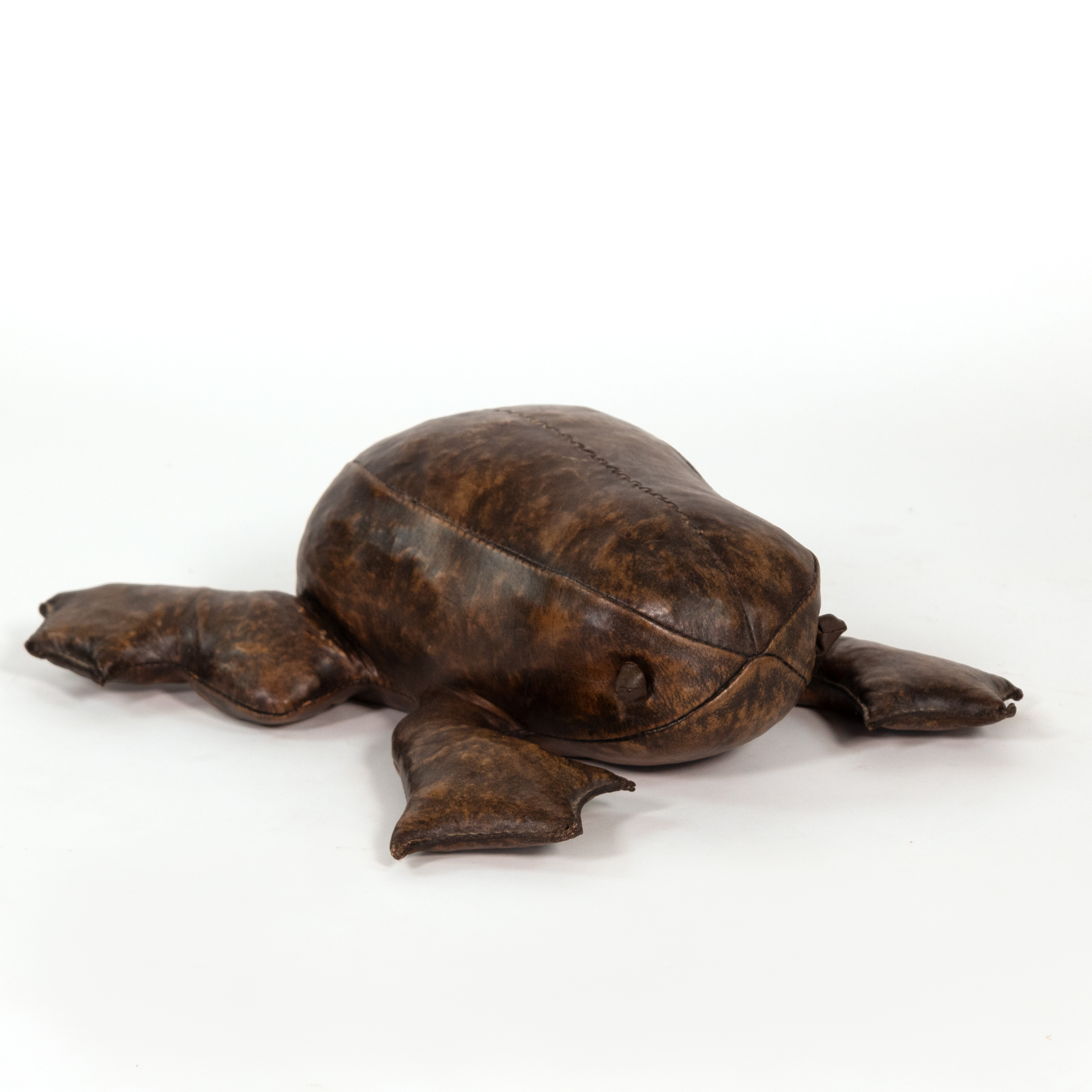 Front three-quarter view of leather frog footstool in the manner of Dimitri Omersa with knotted leather eye