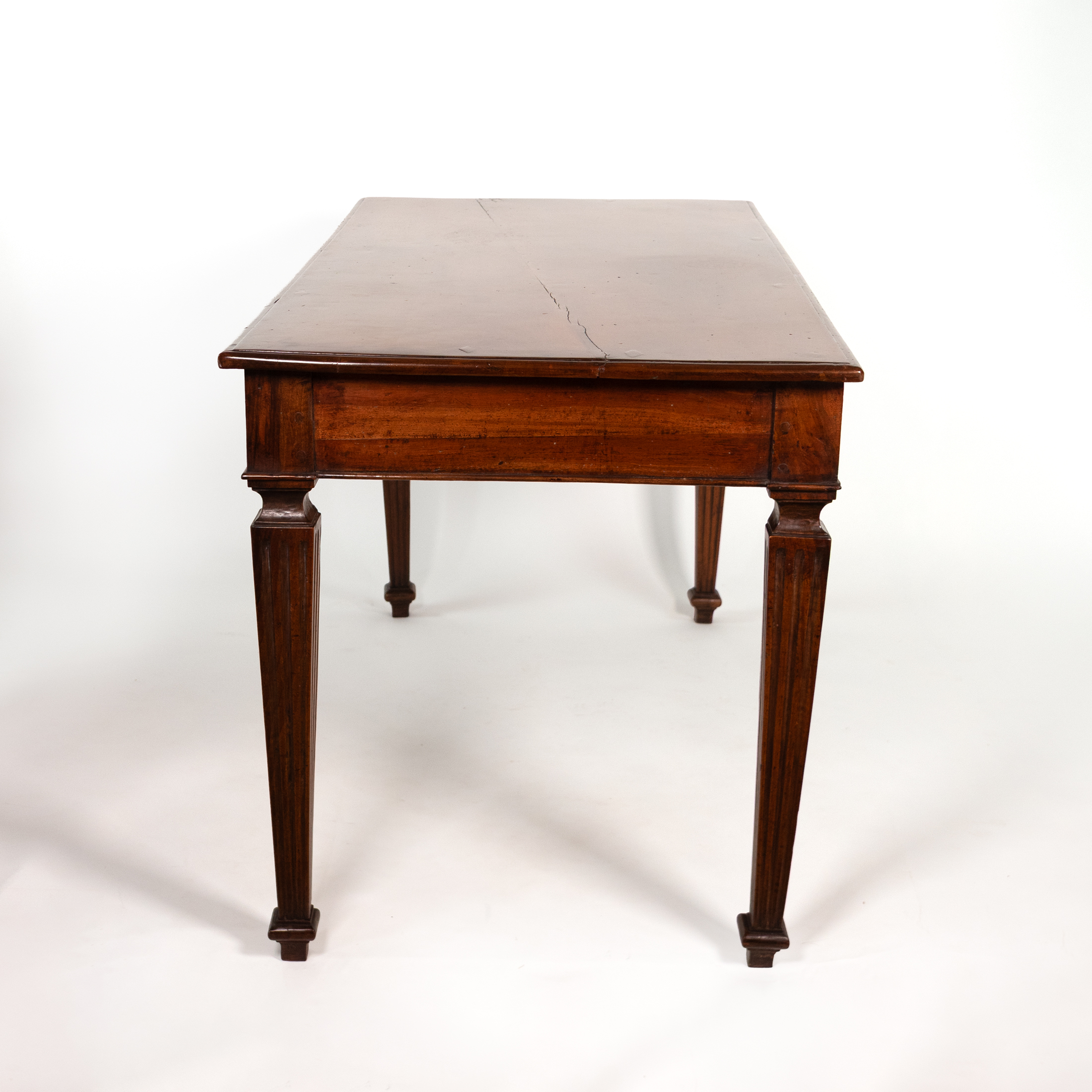 Italian walnut writing table, circa 1800, end view with fluted tapering legs.