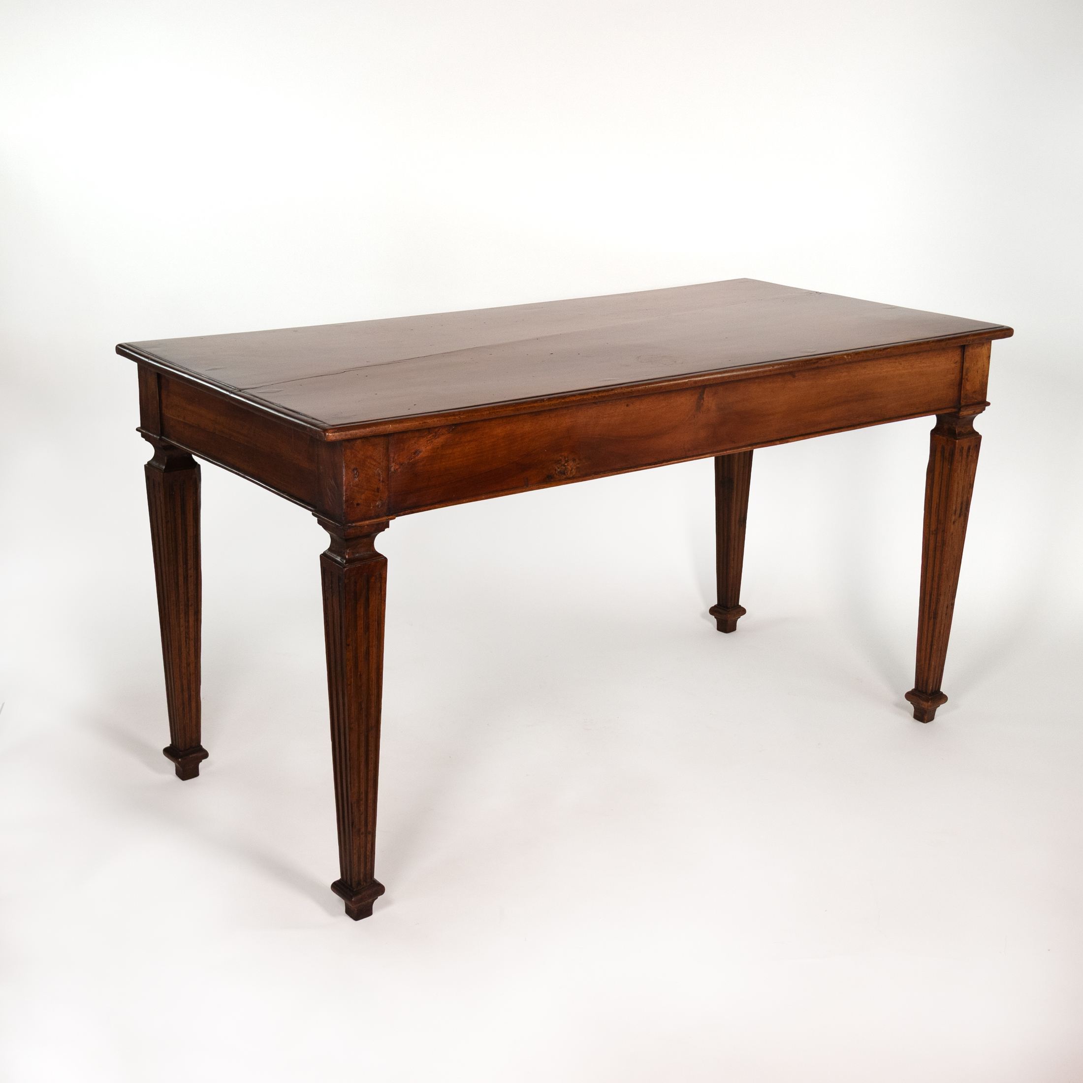 Italian walnut writing table, circa 1800, rear three-quarter view.