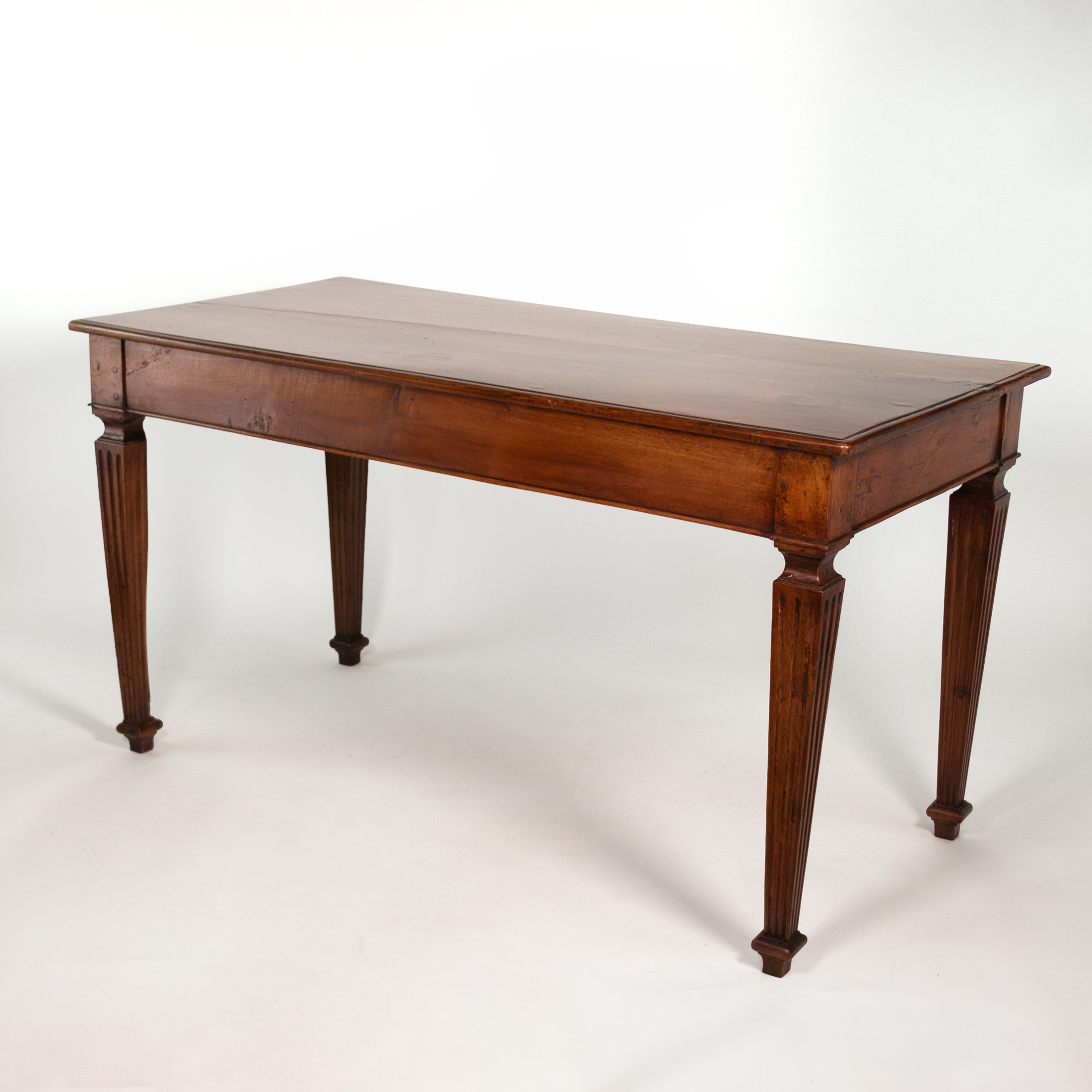 Italian walnut writing table, circa 1800, rear three-quarter perspective.