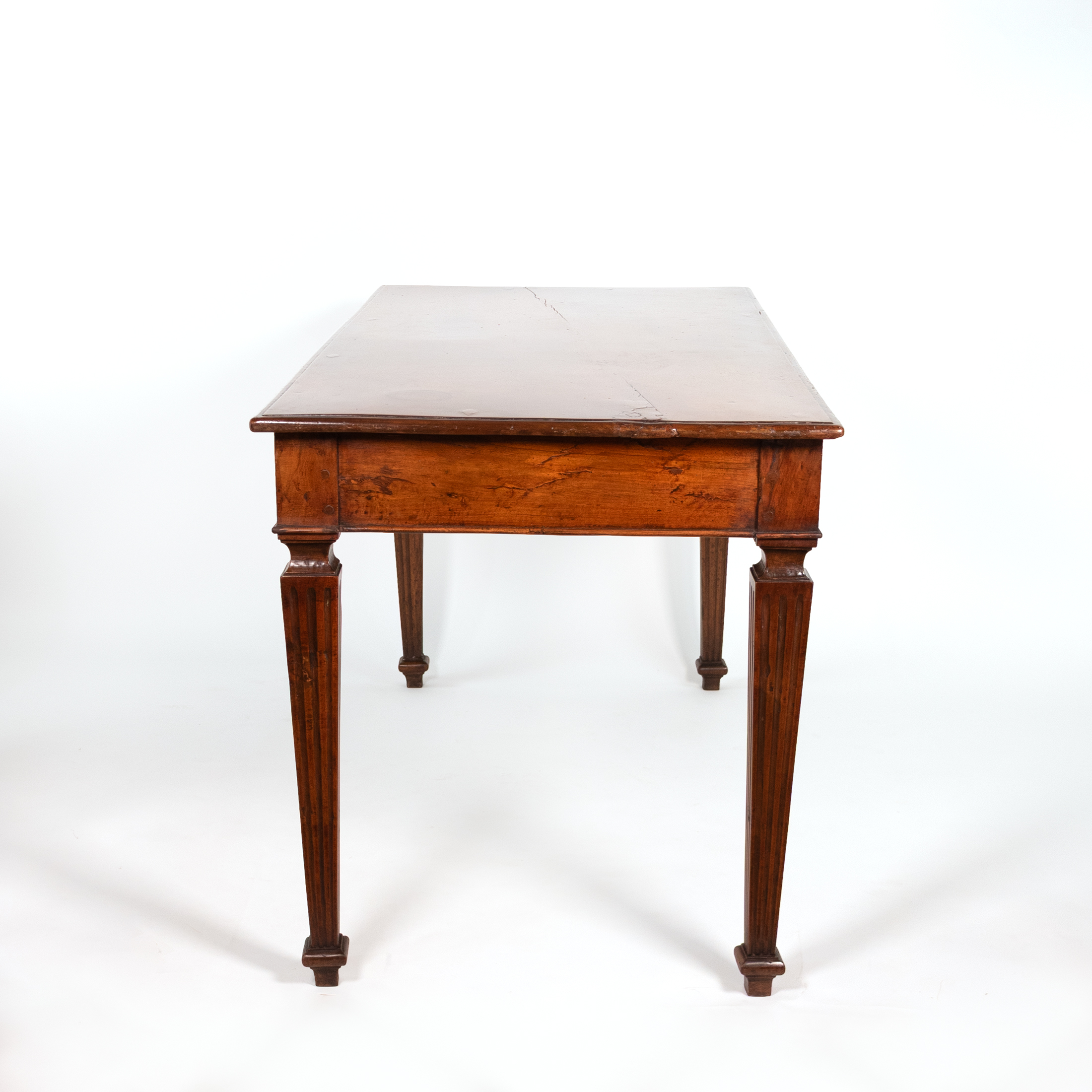 Italian walnut writing table, circa 1800, side view with square fluted legs.