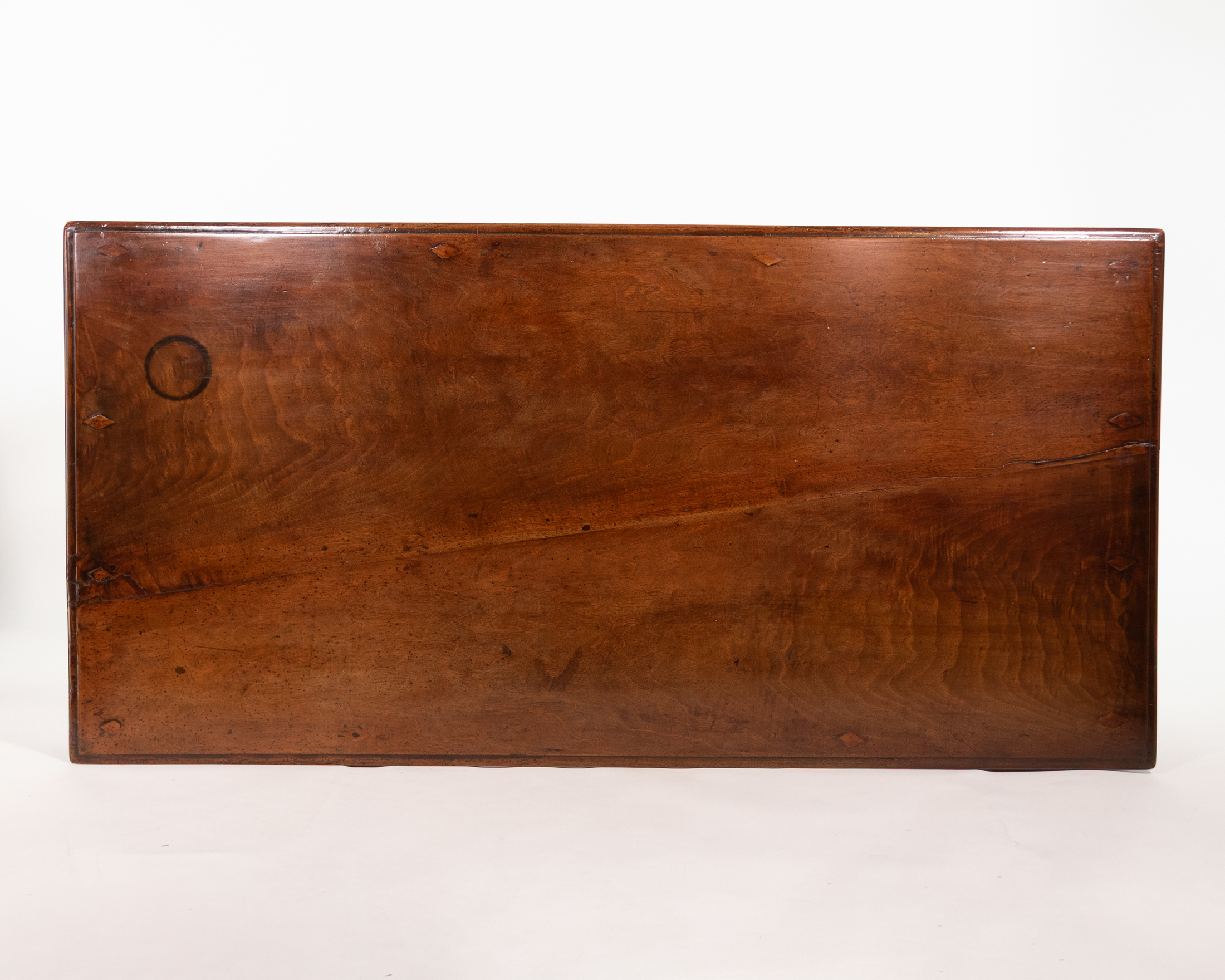 Figured walnut top of Italian writing table, circa 1800, with lozenge-shaped wooden keys and age splits.