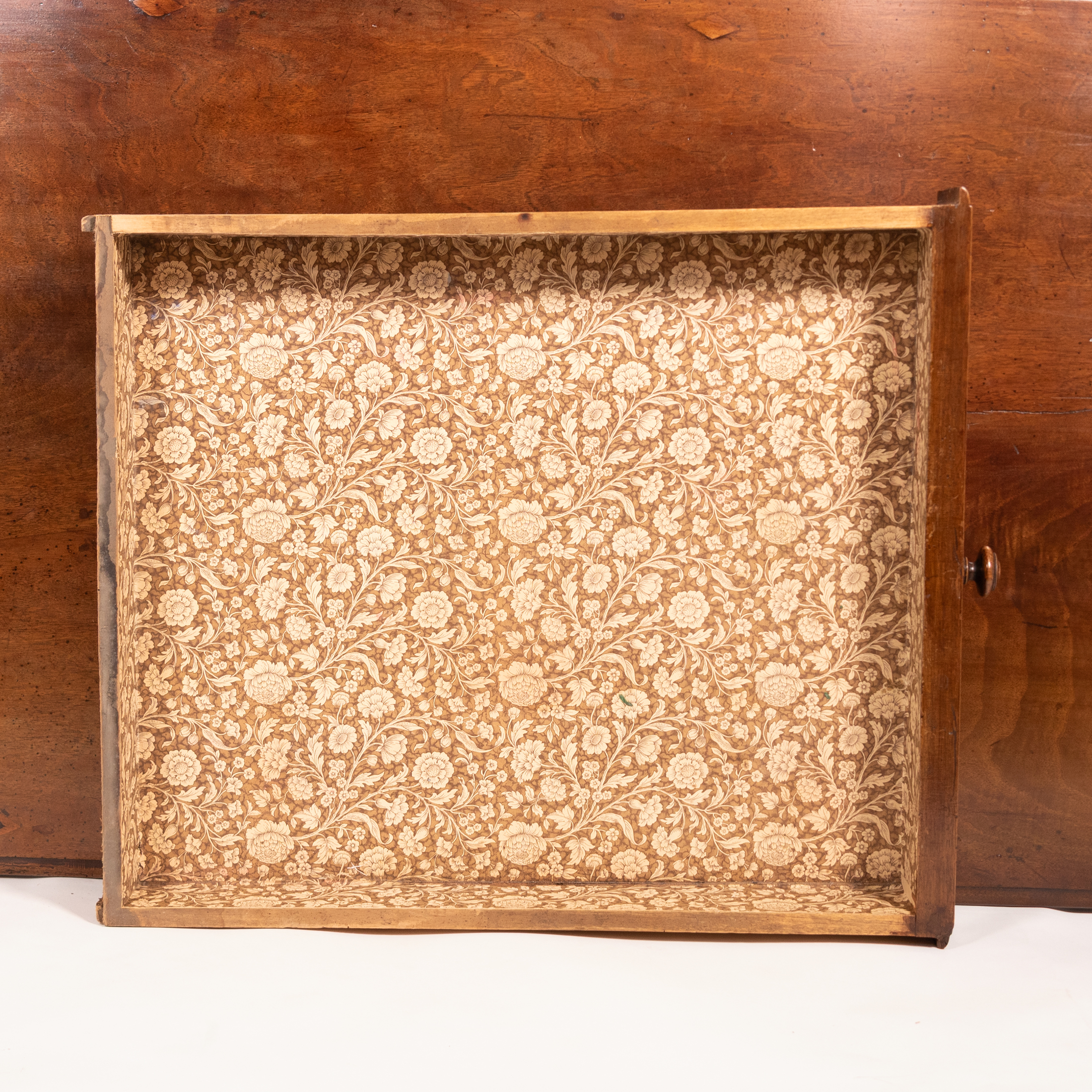 Paper-lined drawer interior of Italian walnut writing table, circa 1800.