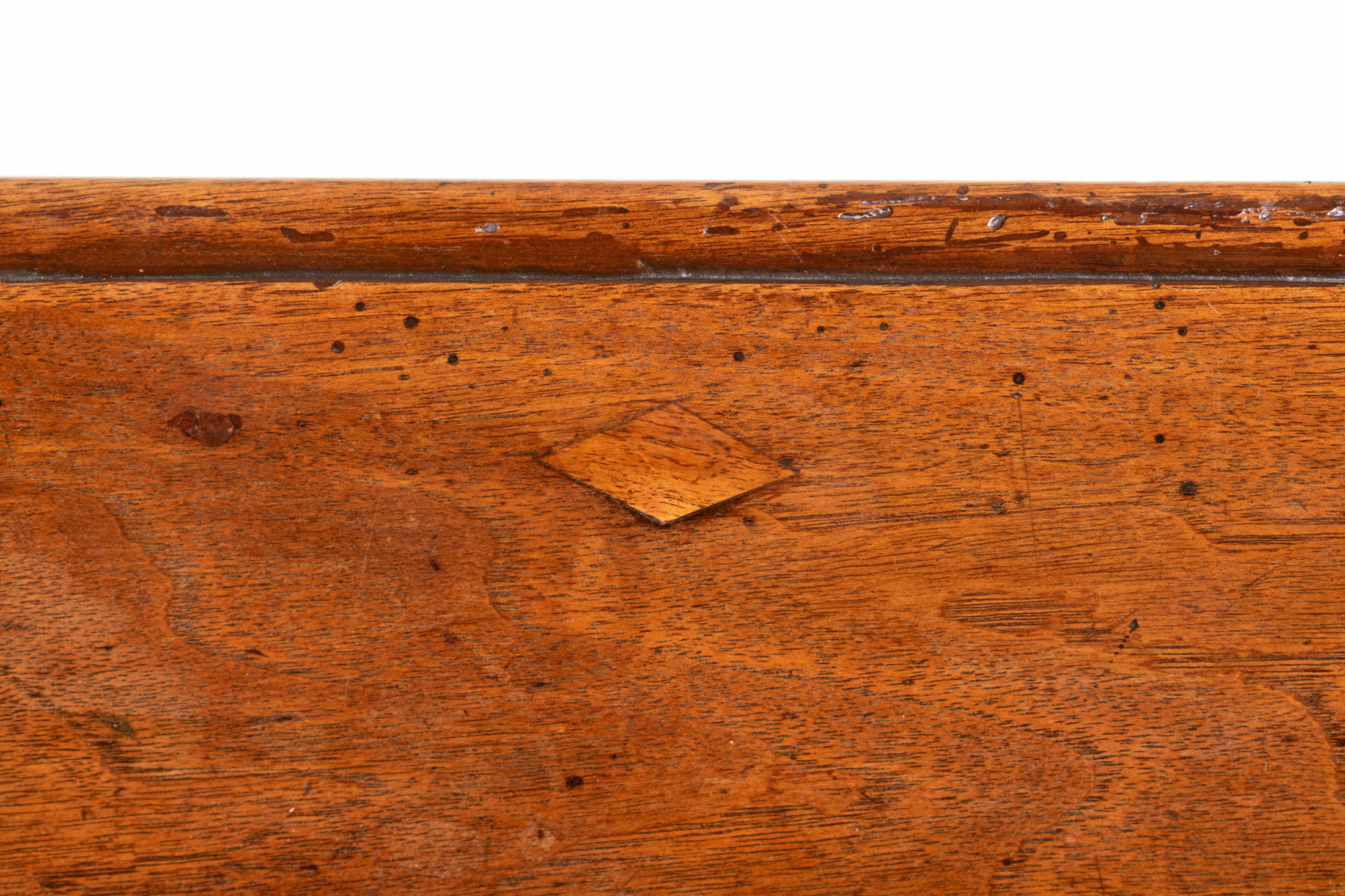 Lozenge-shaped wooden key inset into walnut writing table top, circa 1800.