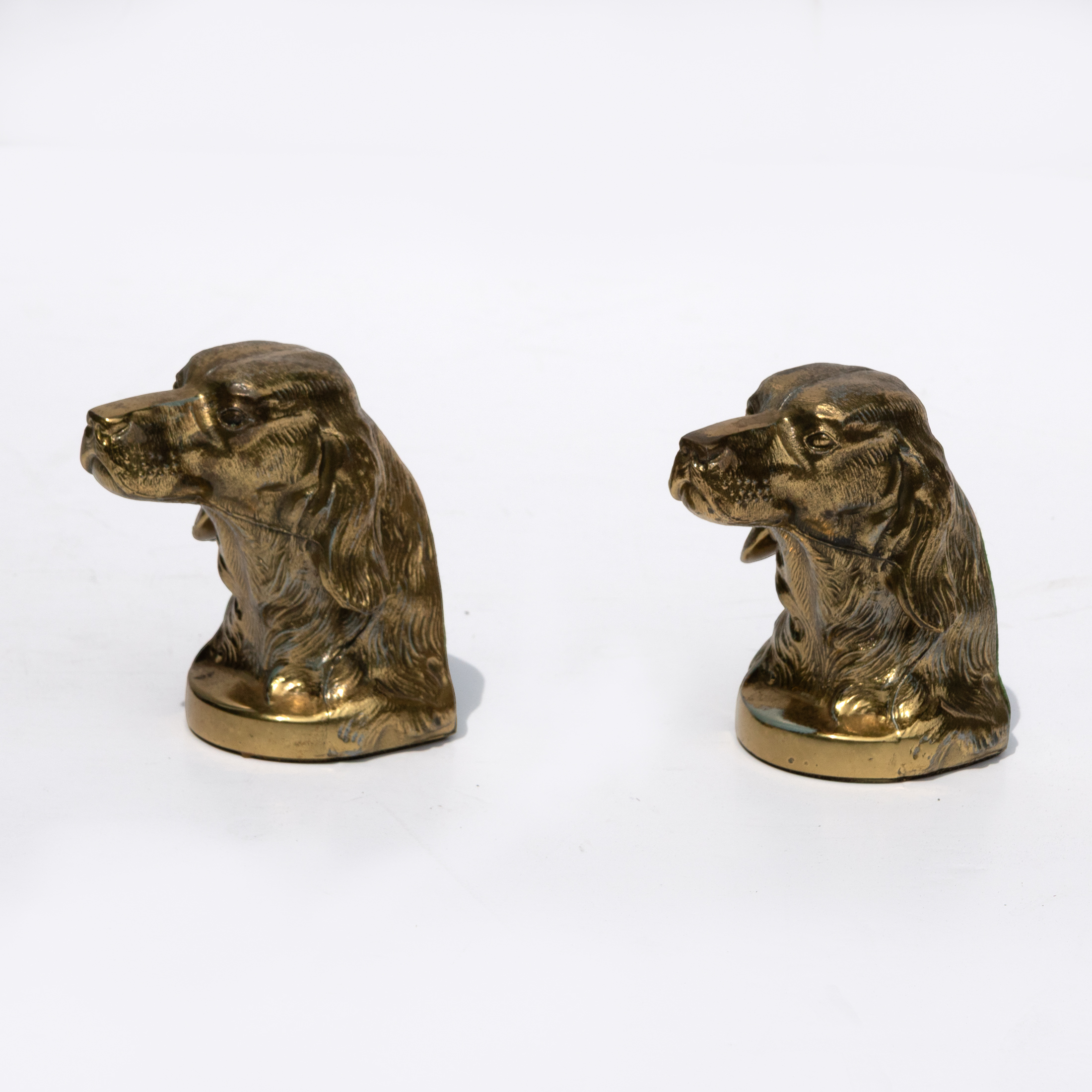 Pair of brass spaniel bookends shown from an alternate three-quarter angle