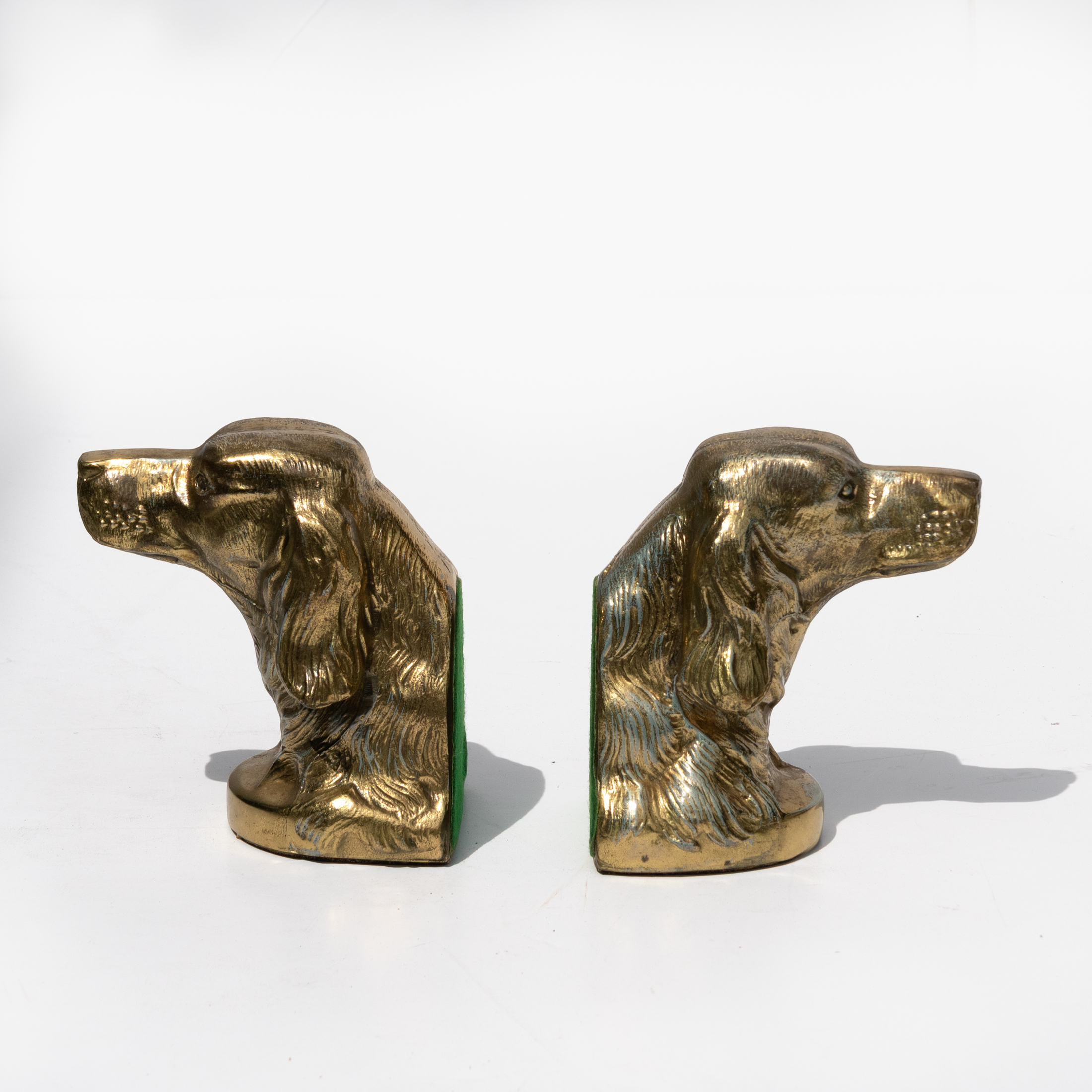 Pair of brass spaniel bookends shown in opposing side profile