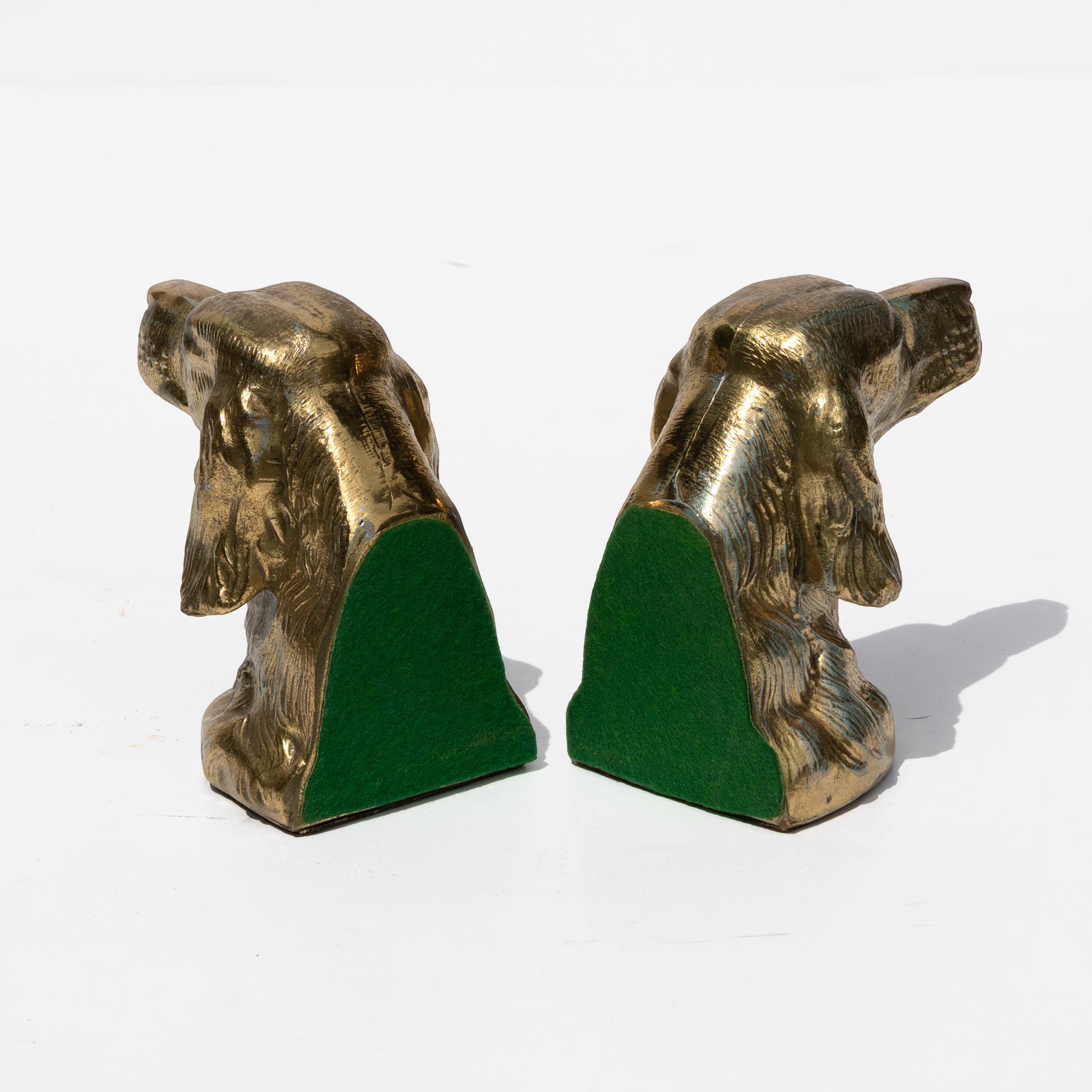 Rear view of brass spaniel bookends showing green felt book-facing backs