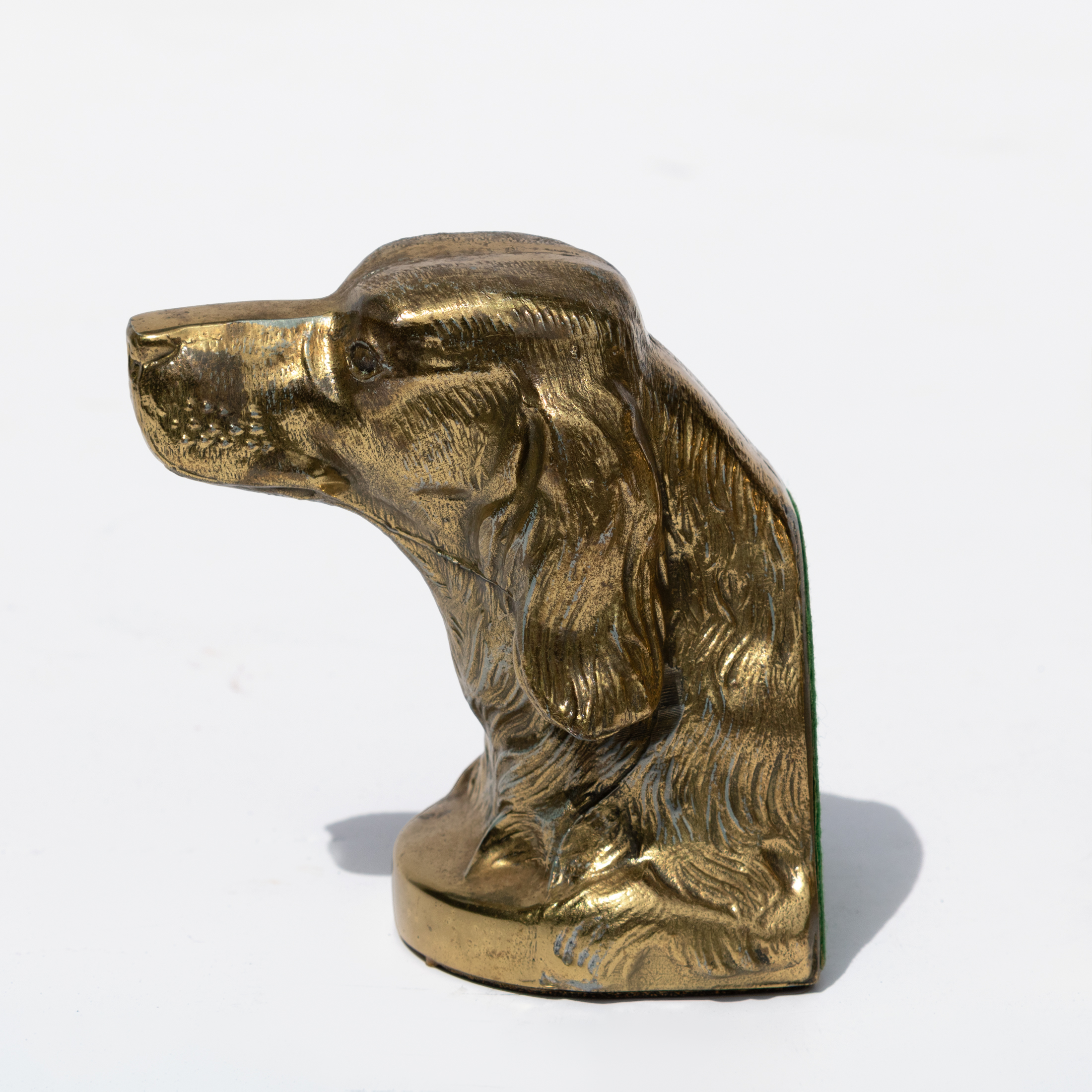 Single brass spaniel dog-head bookend shown in profile