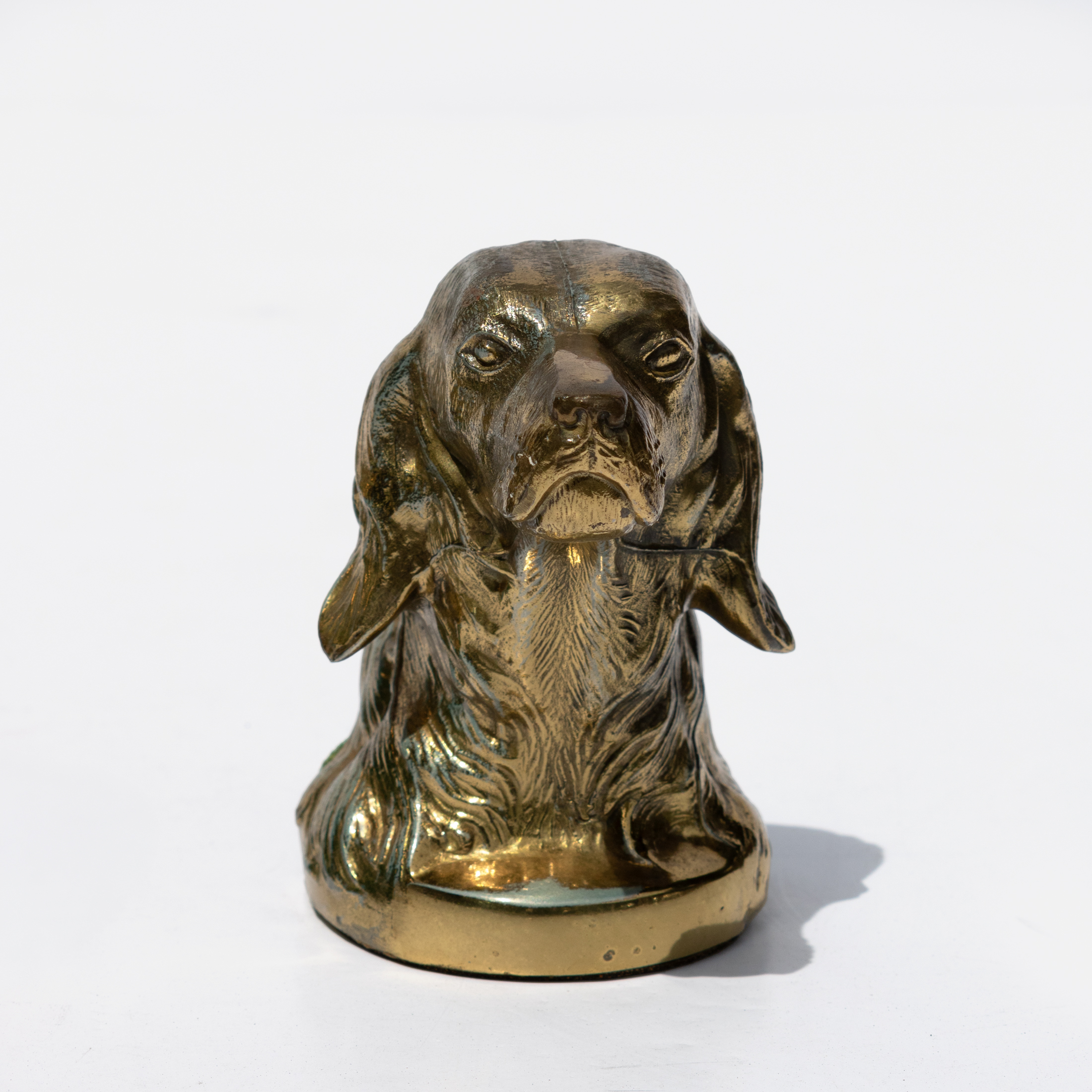 Single brass spaniel dog-head bookend viewed from the front