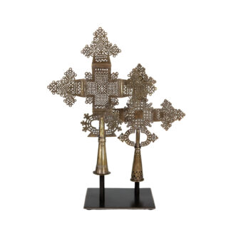 Pair of Ethiopian Orthodox processional crosses in pierced brass on a steel display stand