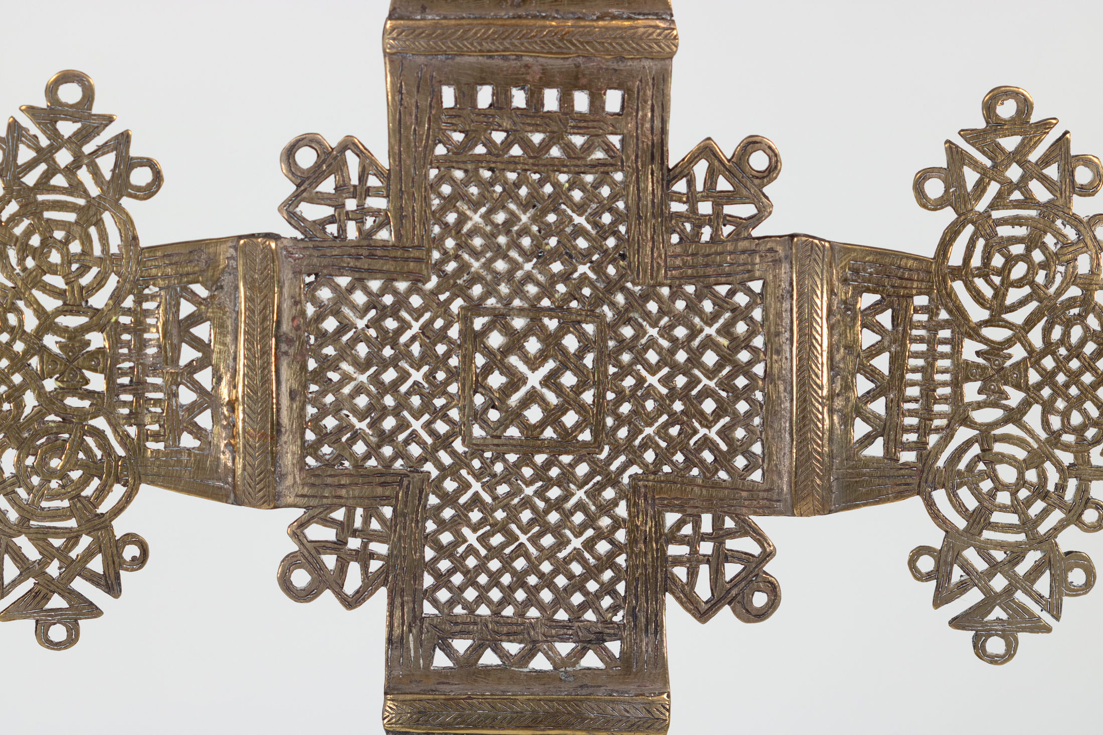 Detail of Ethiopian processional cross central latticework with herringbone-incised brass collars